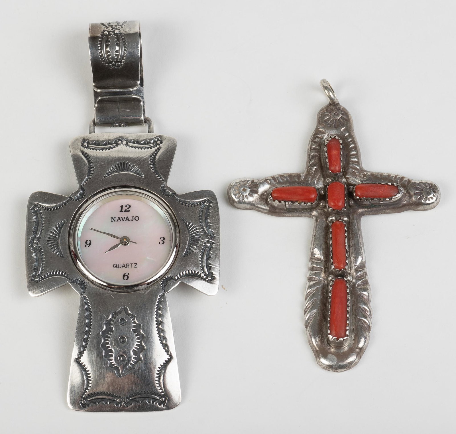 2 Sterling Cross Pendants: Watch pendant signed Uncle Sam W., stamped sterling, 1-1/2" x 3-1/4". Sterling with inlaid coral signed L. Iule, stamped sterling, 1-3/4" x 2-1/2". IMPORTANT: Before bidding, please read the terms and