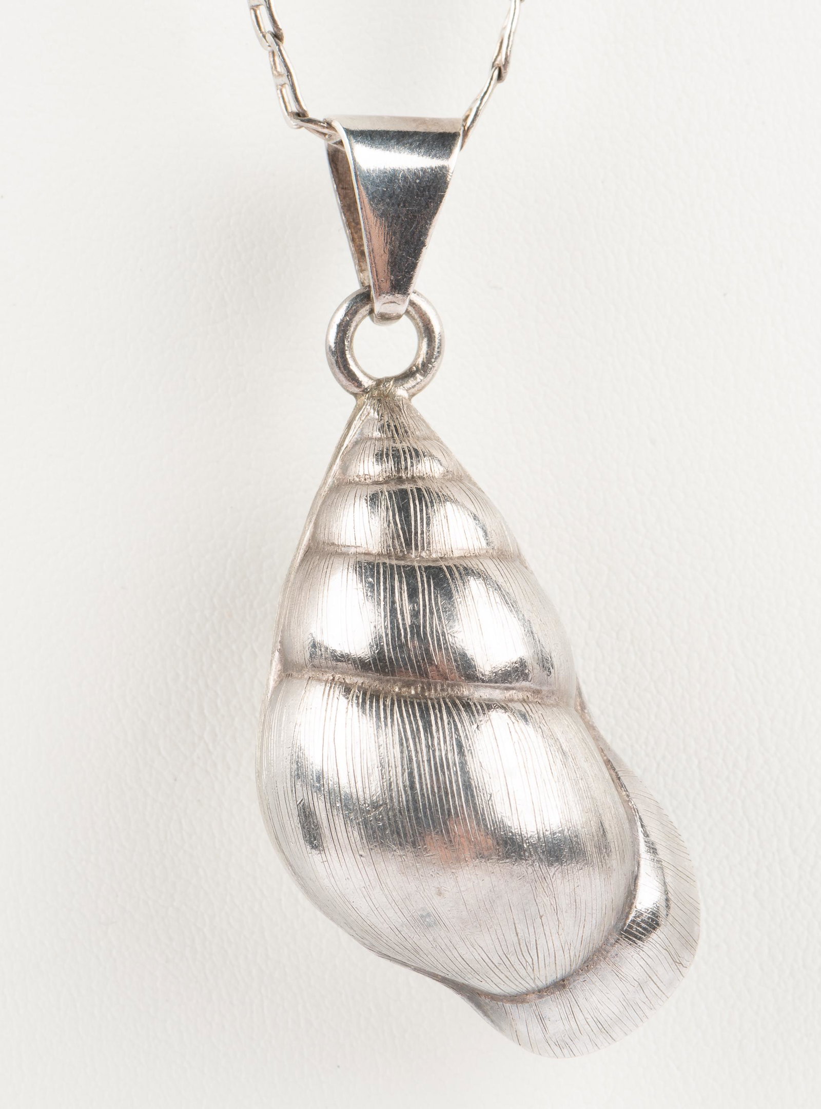 Sterling Seashell Pendant Necklace: Pendant 2-1/2". Chain 26". 0.94 ozt. IMPORTANT: Before bidding, please read the terms and conditions below. When you registered for the auction you agreed to these terms and will be required to comply