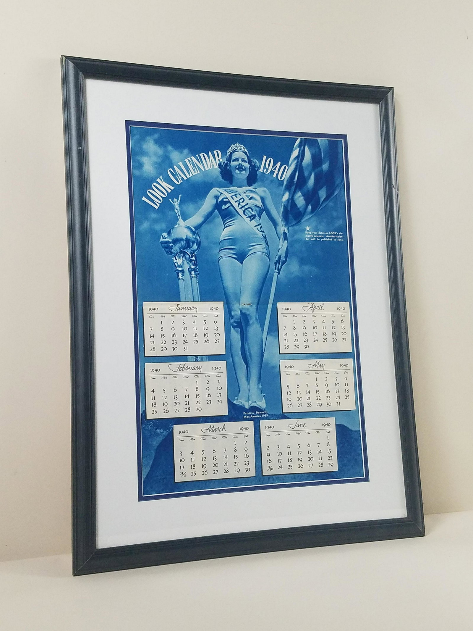 1940 Miss America Look Calendar: Features 1939 Miss America Patricia Donnelly. Overall with frame 27-3/4" high x 20-1/2" wide. Crease at center. 3 rust marks from staples at center.