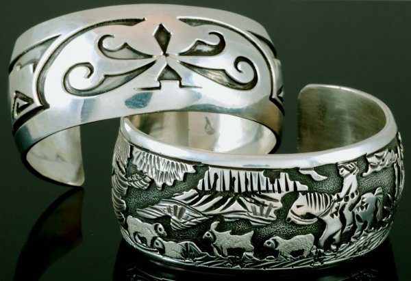 2 Signed Hopi Sterling Cuff Bracelets: DESCRIPTION: A Hopi sterling overlay cuff bracelet of sheep and a figure on horseback. Marked "JJ Sterling". Together with a second Hopi silver cuff bracelet with geometric motifs. Signed with unident