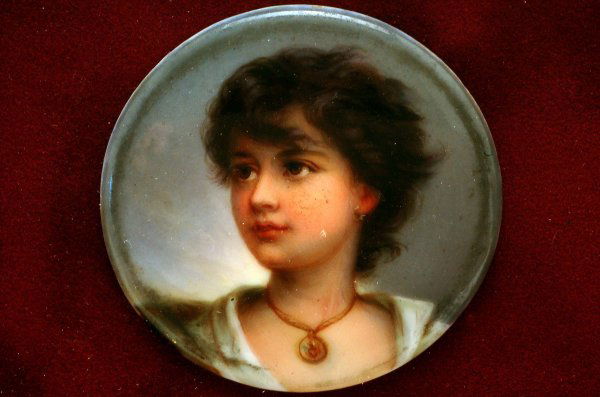 Miniature Portrait Plaque After Richter: DESCRIPTION: A KPM style handpainted miniature portrait plaque of Neapolitane or Gypsy Boy after Richter. Unmarked. Mounted in contemporary shadow box frame. MEASUREMENTS: 1-13/16" diameter. Overall w