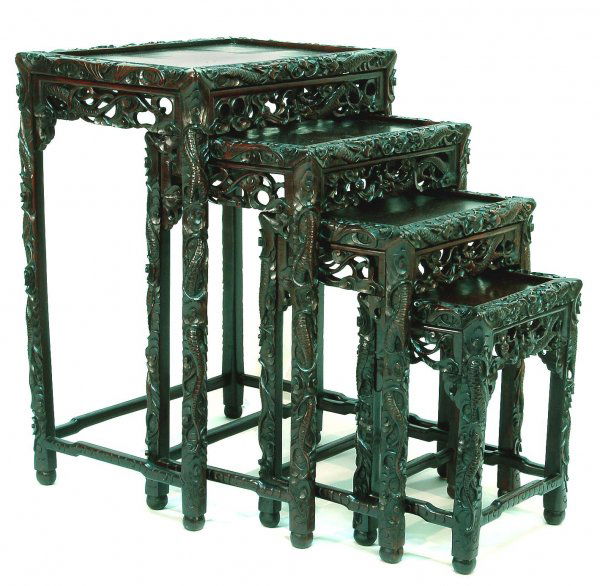 Set of Four Chinese Rosewood Nesting Tables: DESCRIPTION: Set of four Chinese rosewood nesting tables. Profusely carved with dragons and foliage. Circa 1900 to 1910. MEASUREMENTS: Largest 21" x 14" top x 28". Smallest 12-1/4" x 8-1/4" top x 15-1