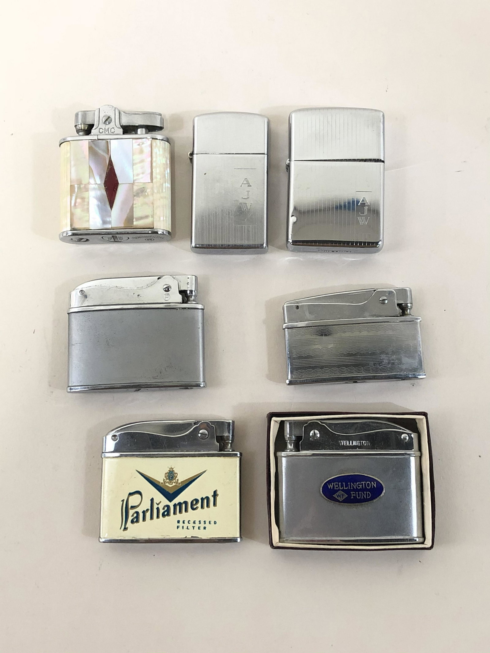 7 Lighters Including Zippo: Also includes Continental, Parliament, Wellington Fund, and Modern.