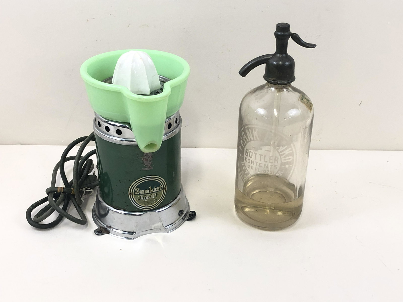 Sunkist Jadite Juicer & Frank Banko Seltzer Bottle: Juicer 4" to 5 1/2" wide x 4" to 5 1/2" deep x 9 1/2 to 11" high. Hairline crack to jadeite.
