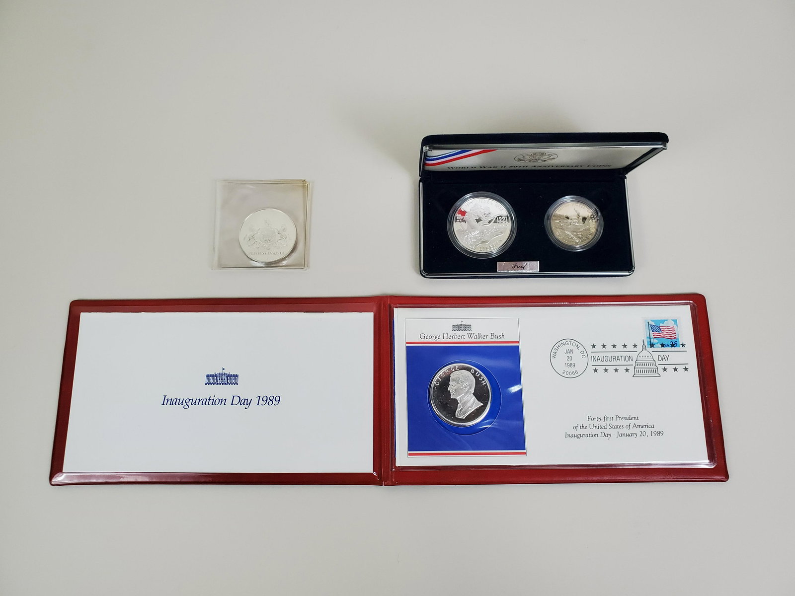 3 Silver & 1 Clad Commemorative Coins: WW II 50th anniversary proof silver dollar and clad half dollar. George Bush Inauguration day 1989. Pennsylvania 76.
