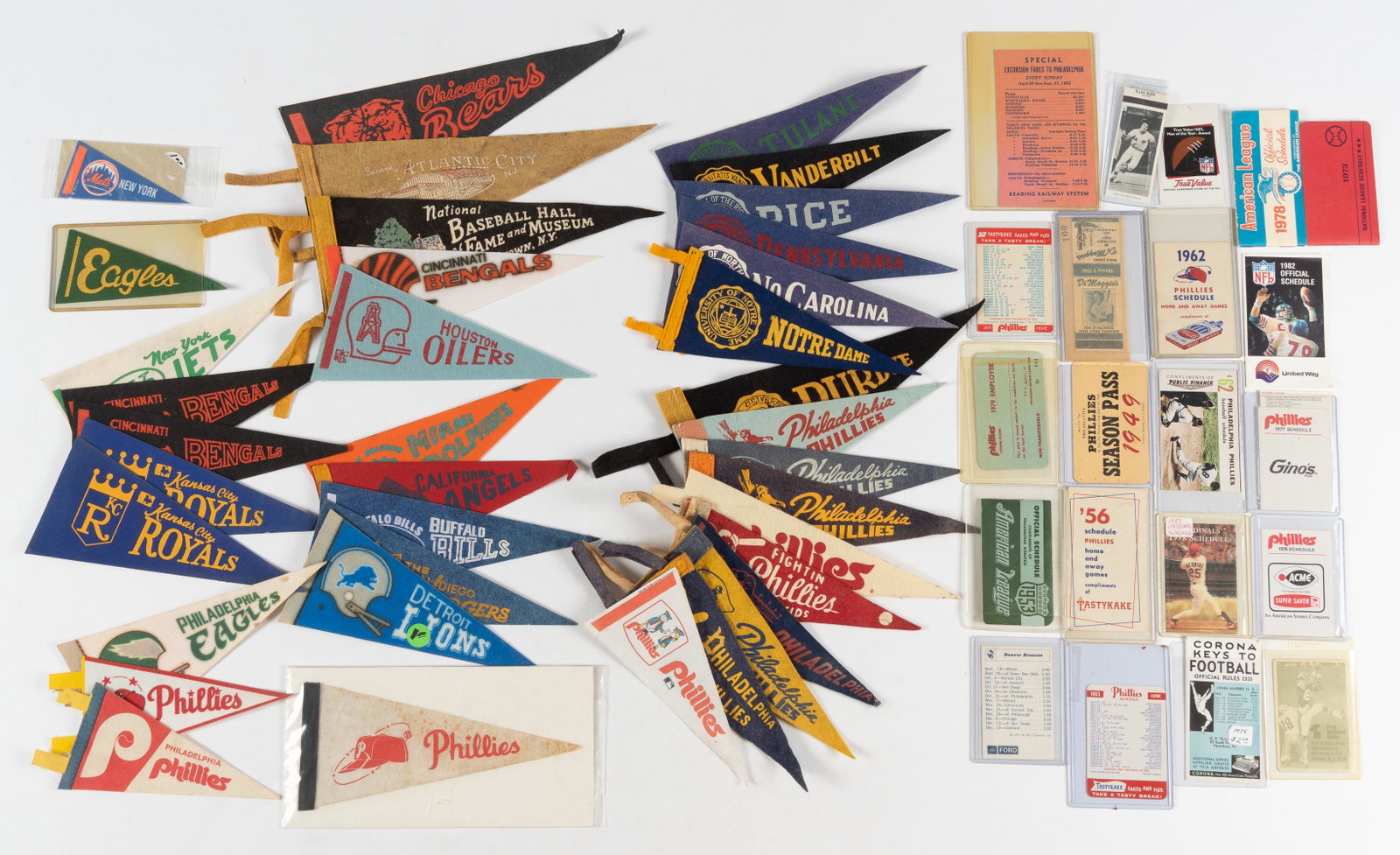Group of Sports Memorabilia with Pennants: DESCRIPTION: Includes college and professional teams, 1956 Phillies schedule, 1953 A. L. schedule, and more. CONDITION: Good to very good. IMPORTANT: Before bidding, please read the terms and conditio