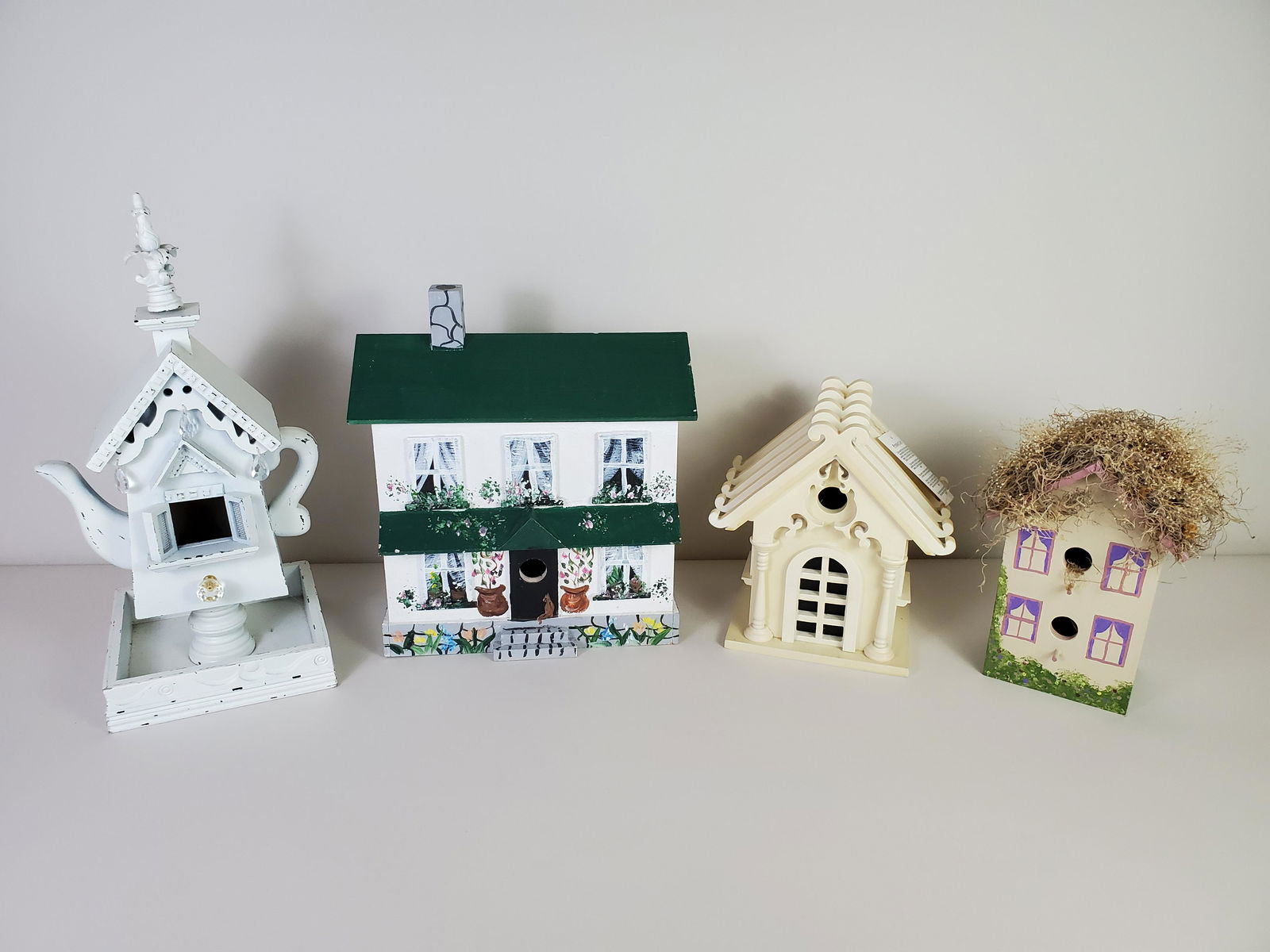 4 Bird Houses: Largest 8" wide X 8" deep X q9 1/2" high. Smallest 9 1/2" wide X 7" deep X 10 1/2" high. IMPORTANT: Before bidding, please read the terms and conditions. When you registered for the auction you agreed