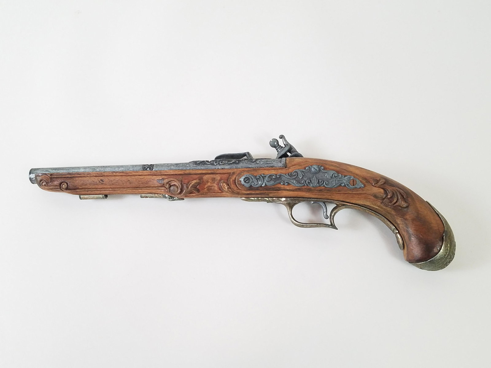 Replica of 1740 Flintlock: 17-1/2" long. IMPORTANT: Before bidding, please read the terms and conditions. When you registered for the auction you agreed to these terms and will be required to comply with them.
