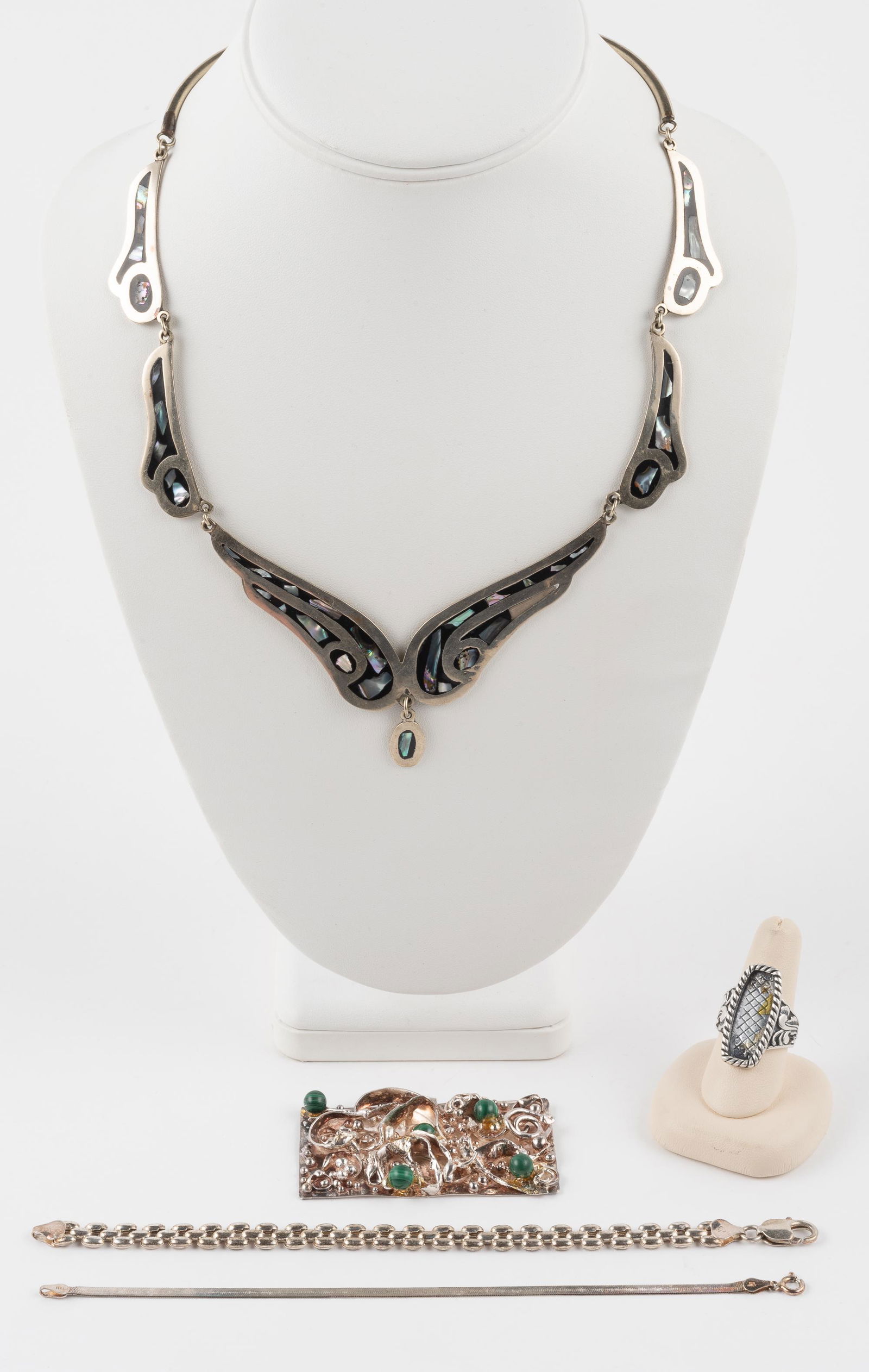 Group of Silver Jewelry: Alpaca abalone inlaid necklace 18". Bracelets 7" and 7-1/4". Ring missing stone. Size 7. Necklace missing portion of inlay. 1.8 ozt not including necklace. IMPORTANT: Before bidding, please read the t