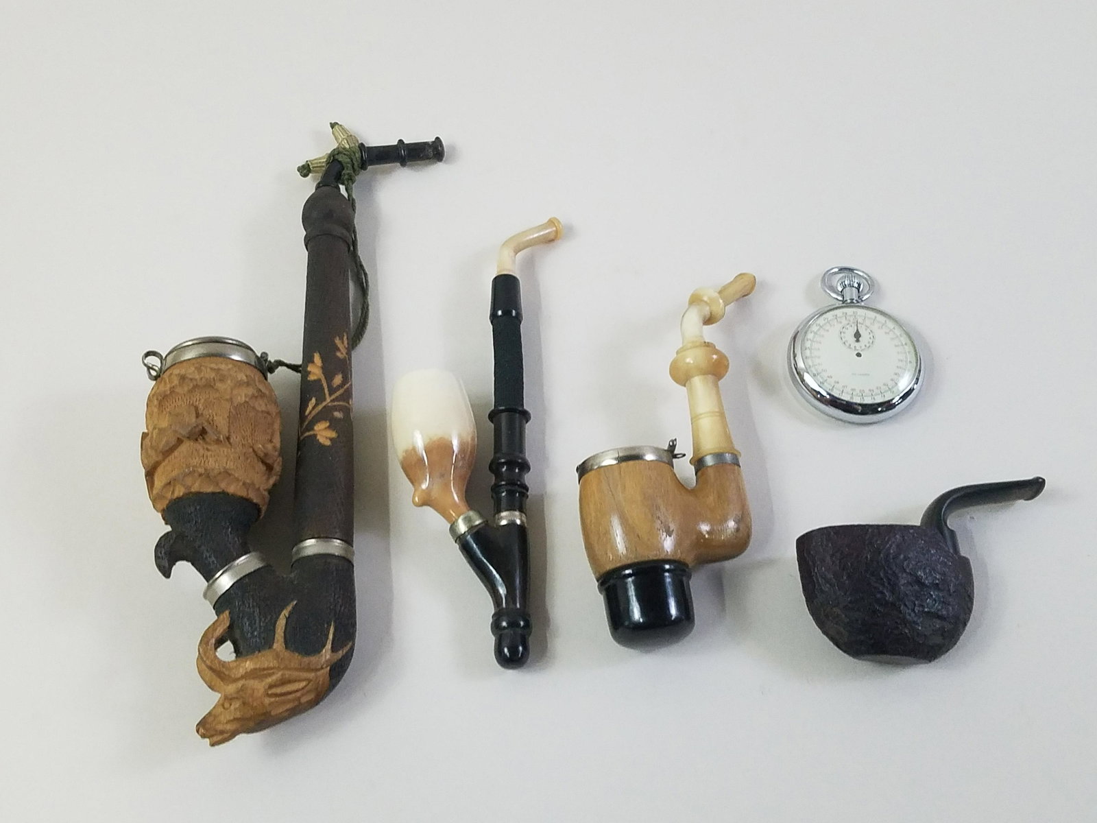 4 Pipes and Delgard Stop Watch: Watch with box. Pipes 2-3/4" to 8-3/4" long. IMPORTANT: Before bidding, please read the terms and conditions. When you registered for the auction you agreed to these terms and will be required to comp
