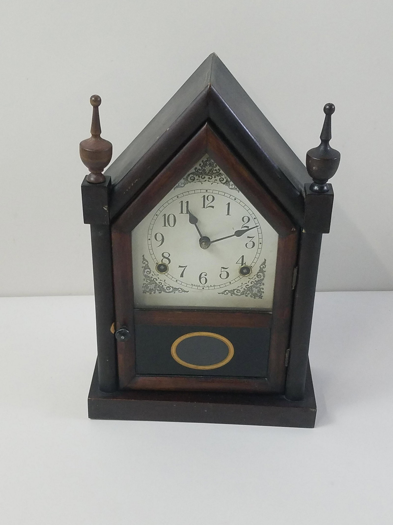 Mantle Clock: Made in USA. Starts and stops. 9-1/4" wide x 4" deep x 14" high. Some finish losses. IMPORTANT: Before bidding, please read the terms and conditions. When you registered for the auction you agreed to 