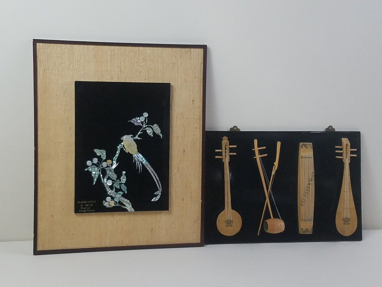 2 Lacquered Wall Hangings incl MOP and Instruments: Mother of pearl bird in tree by Tae Won Pak to Alfred H. Victor Jr. Overall with frames 12" to 21" high x 17-1/2" to 18" wide. IMPORTANT: Before bidding, please read the terms and conditions. When you