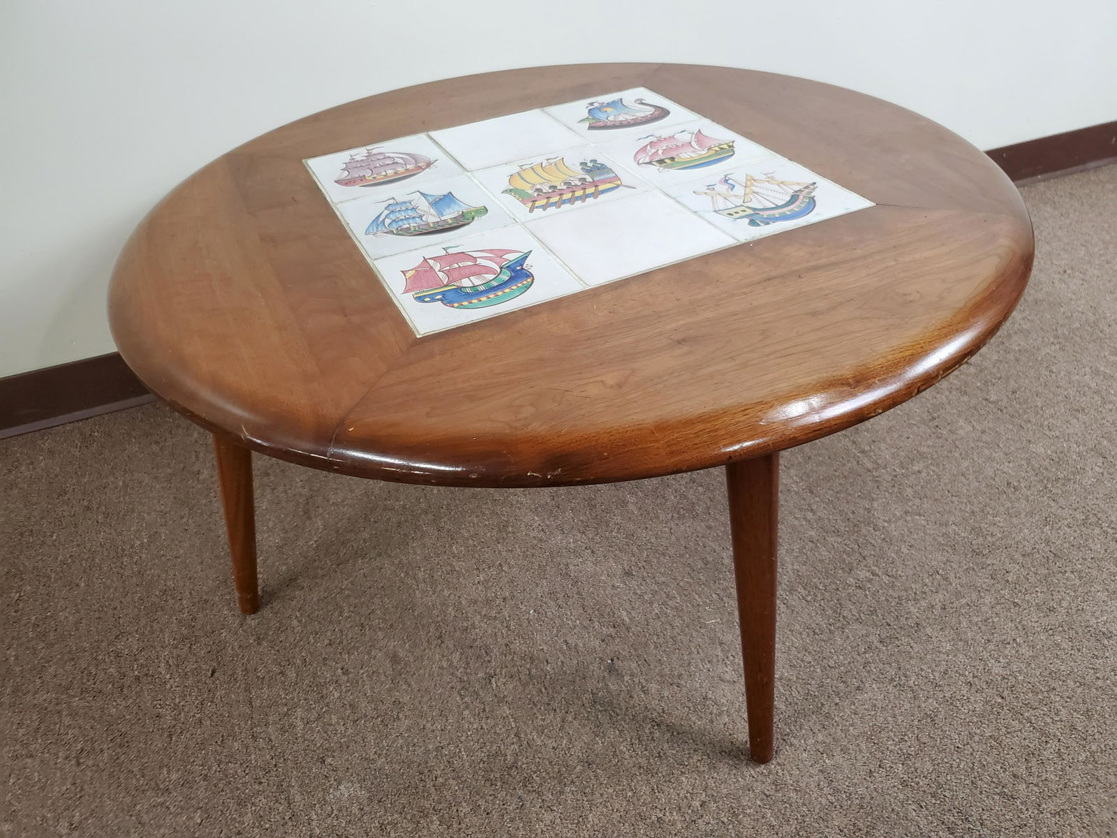 Round Coffee Table With Inlaid Tiles: 36" diameter X 18 1/2" high. IMPORTANT: Before bidding, please read the terms and conditions. When you registered for the auction you agreed to these terms and will be required to comply with them.