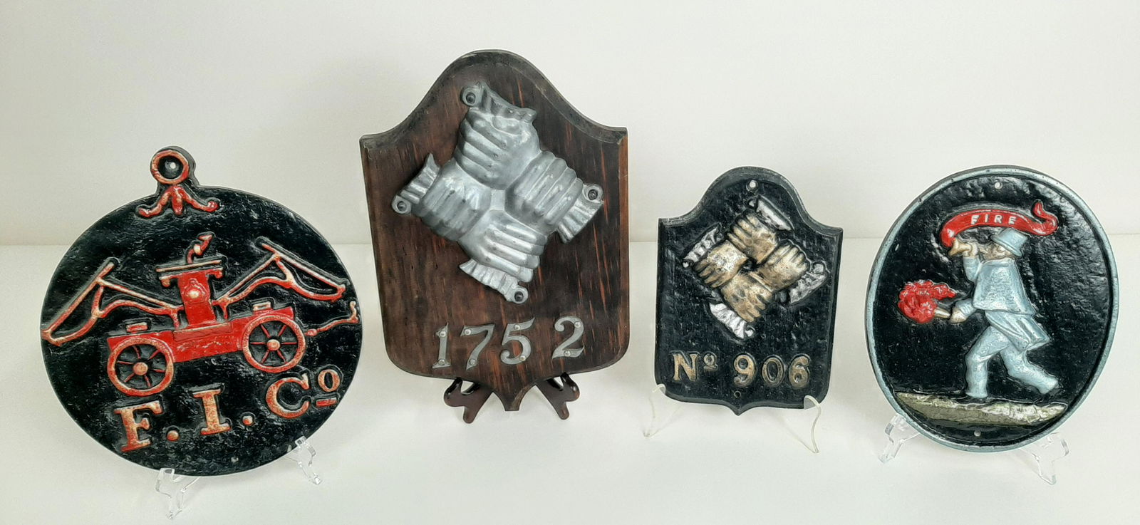 4 Firemarks incl Wood and Metal: 3 made by Walter E. Lee, Inc. 7" to 11" wide X 10¼" to 15" high. IMPORTANT: Before bidding, please read the terms and conditions. When you registered for the auction you agreed to these terms a