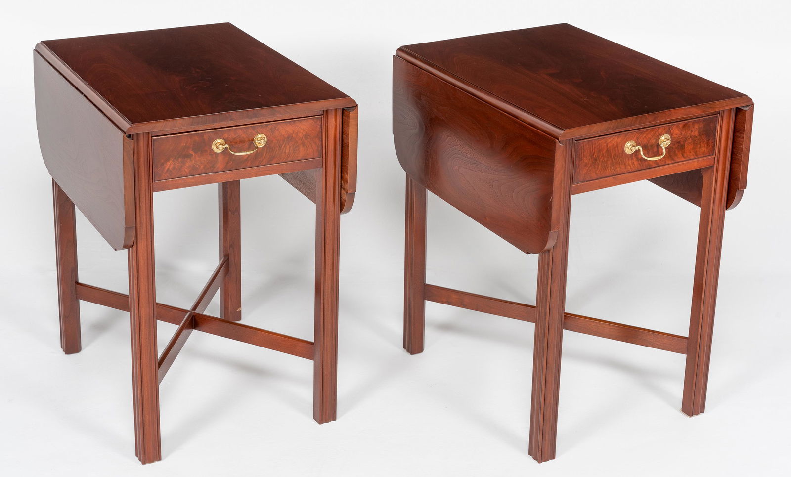 Pair of Irion Company Drop-Side End Tables: DESCRIPTION: Pair of Irion Company walnut Pembroke style drop side end tables. Each with single drawer. Brass pulls. MEASUREMENTS: Each 37" wide x 24" deep x 28-1/2" high; 18-1/2" not extended. CONDIT