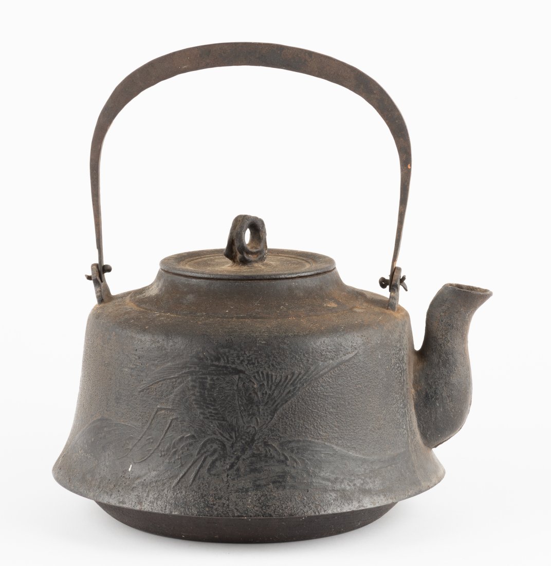 Japanese Cast Iron Tetsubin: DESCRIPTION: Large Japanese cast iron tetsubin with lid. Reliefs of birds to each side. MEASUREMENTS: 9-5/8" high x 12-1/8" wide; 14-1/4" high with handle up. 8-1/4" deep. CONDITION: Corrosion, loss t