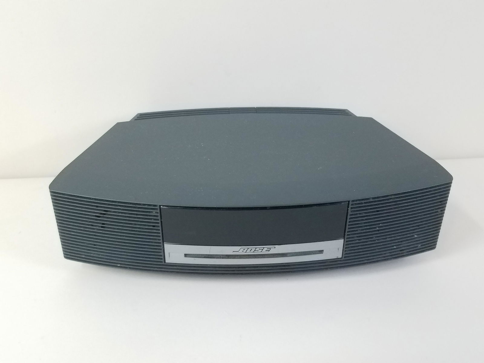 Bose Wave Music System: Powers on. Model AWRCC1. IMPORTANT: Before bidding, please read the terms and conditions. When you registered for the auction you agreed to these terms and will be required to comply with them.