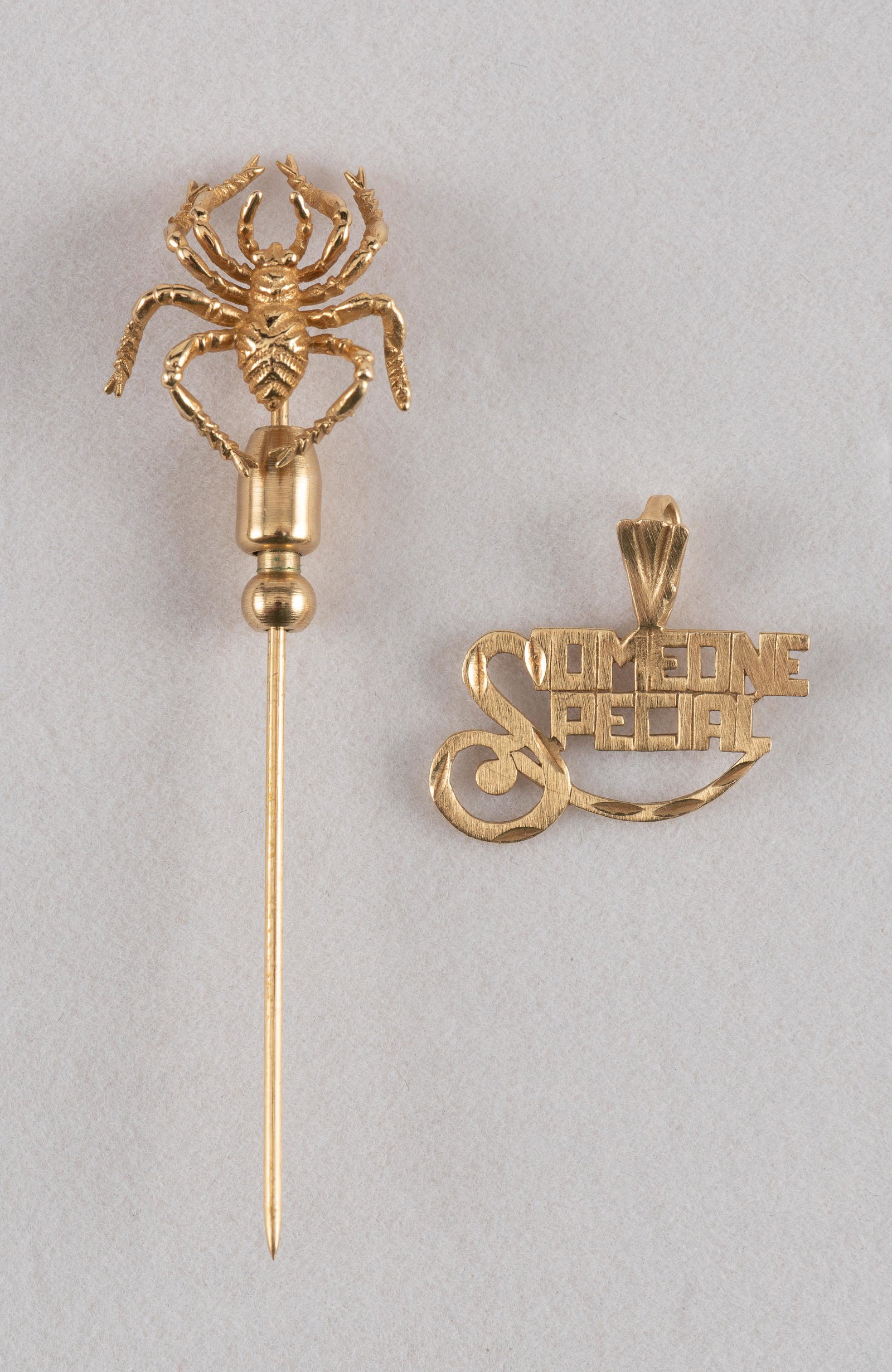 14K Stick Pin & Pendant: Spider stick pin 1-3/4" long. Pendant 3/4" wide. 1.6 dwt without stick pin slide. IMPORTANT: Before bidding, please read the terms and conditions. When you registered for the auction you agreed to the