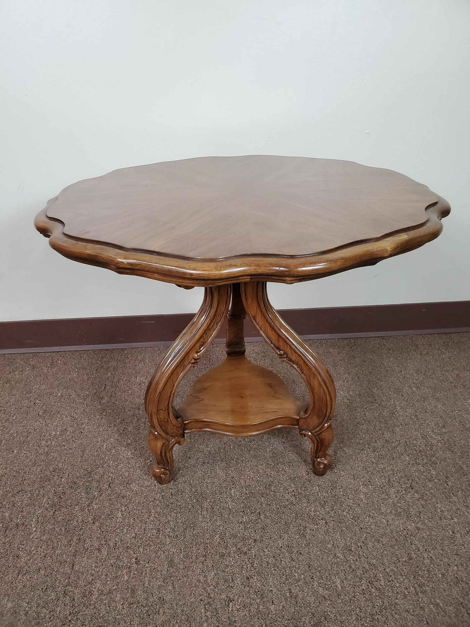 Carved Wood Side Table: 26" diameter X 22" high. IMPORTANT: Before bidding, please read the terms and conditions. When you registered for the auction you agreed to these terms and will be required to comply with them.