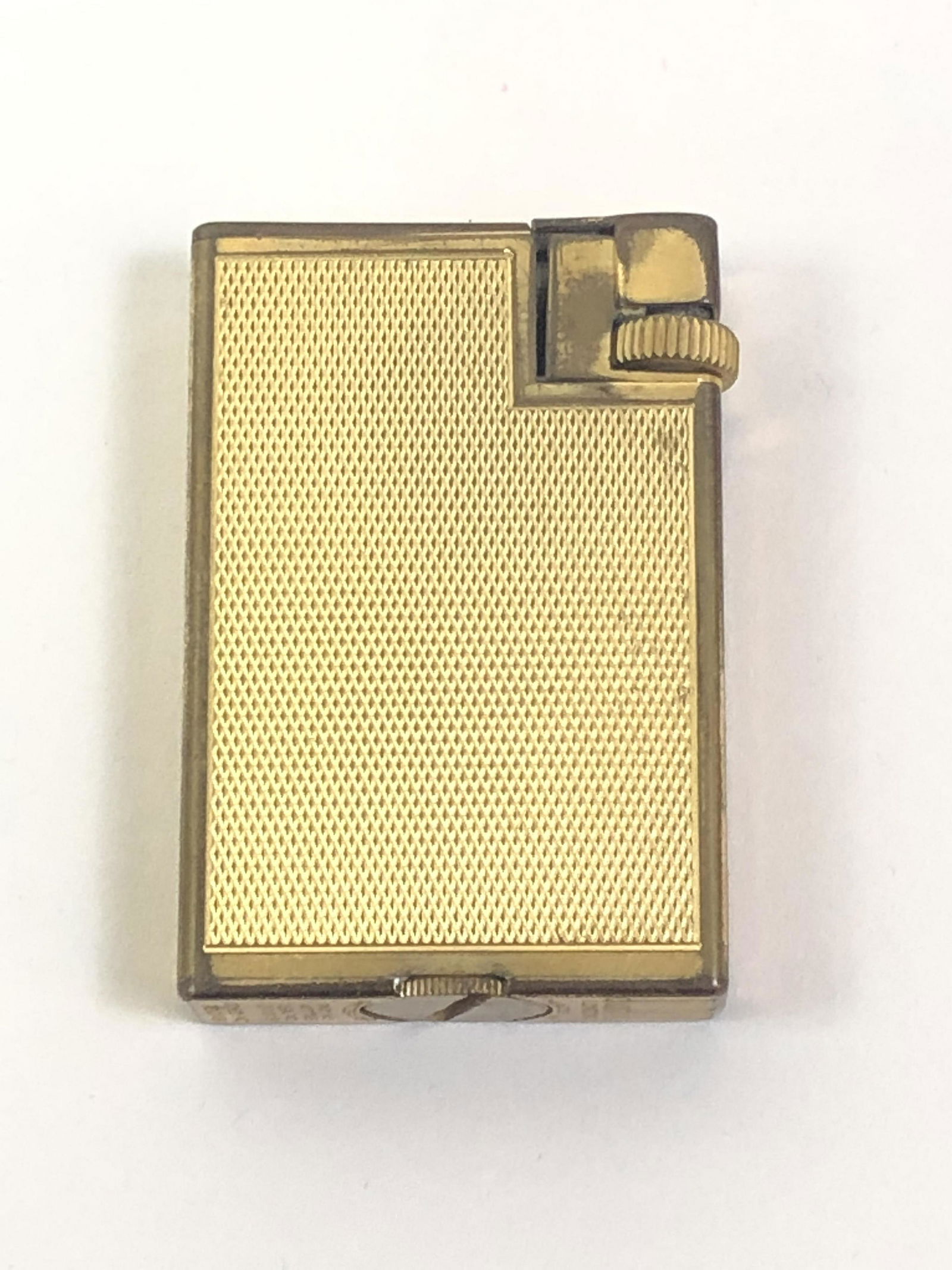 Vintage Dunhill Handy Lighter: Gold plated. 2" high. IMPORTANT: Before bidding, please read the terms and conditions. When you registered for the auction you agreed to these terms and will be required to comply with them.