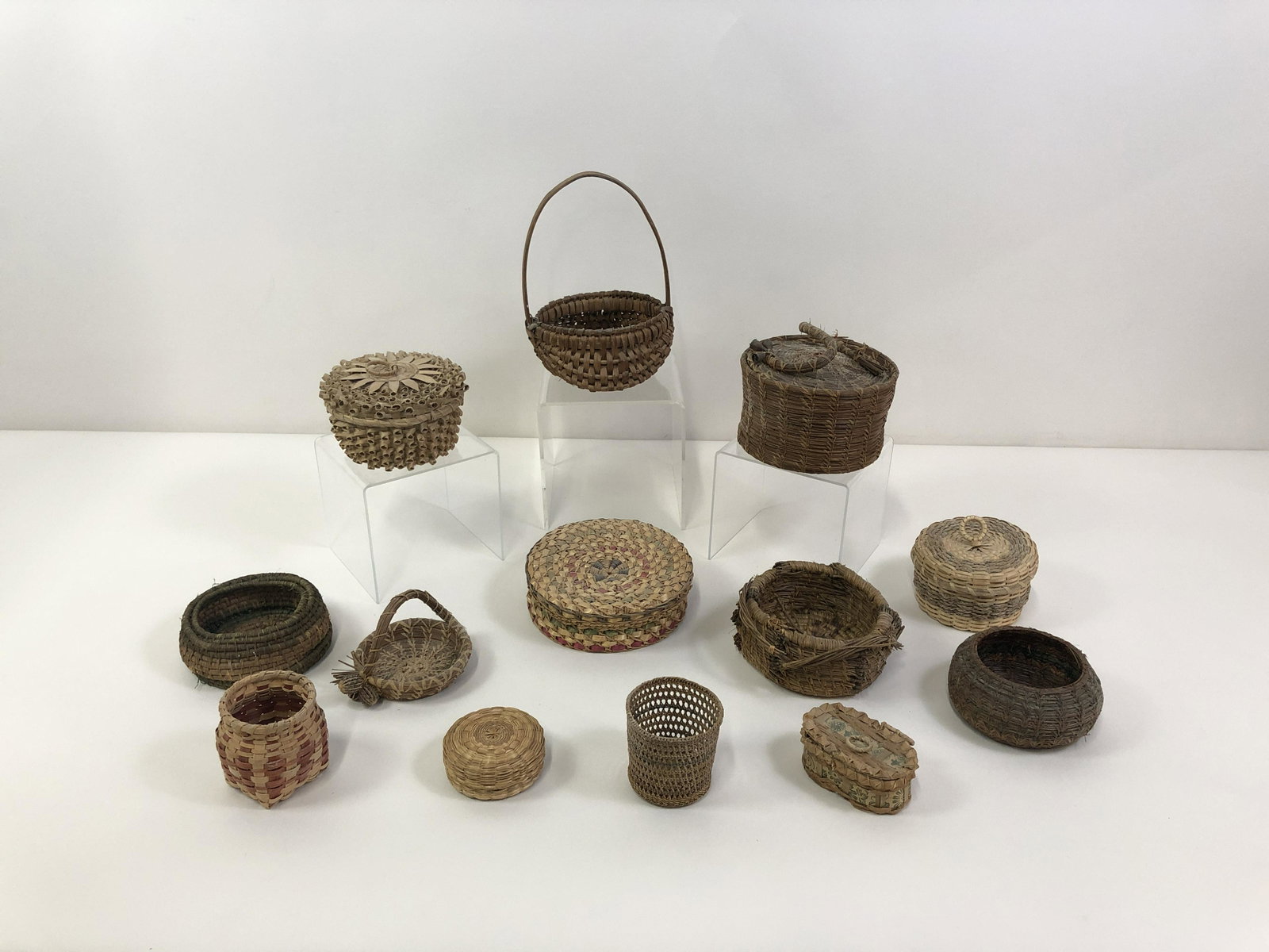 13 Diminutive Baskets: Includes Ash & Swiftgrass, Birchbark, Pine Needle & Buttocks. 1 1/2" to 9" high. IMPORTANT: Before bidding, please read the terms and conditions. When you registered for the auction you agreed to thes