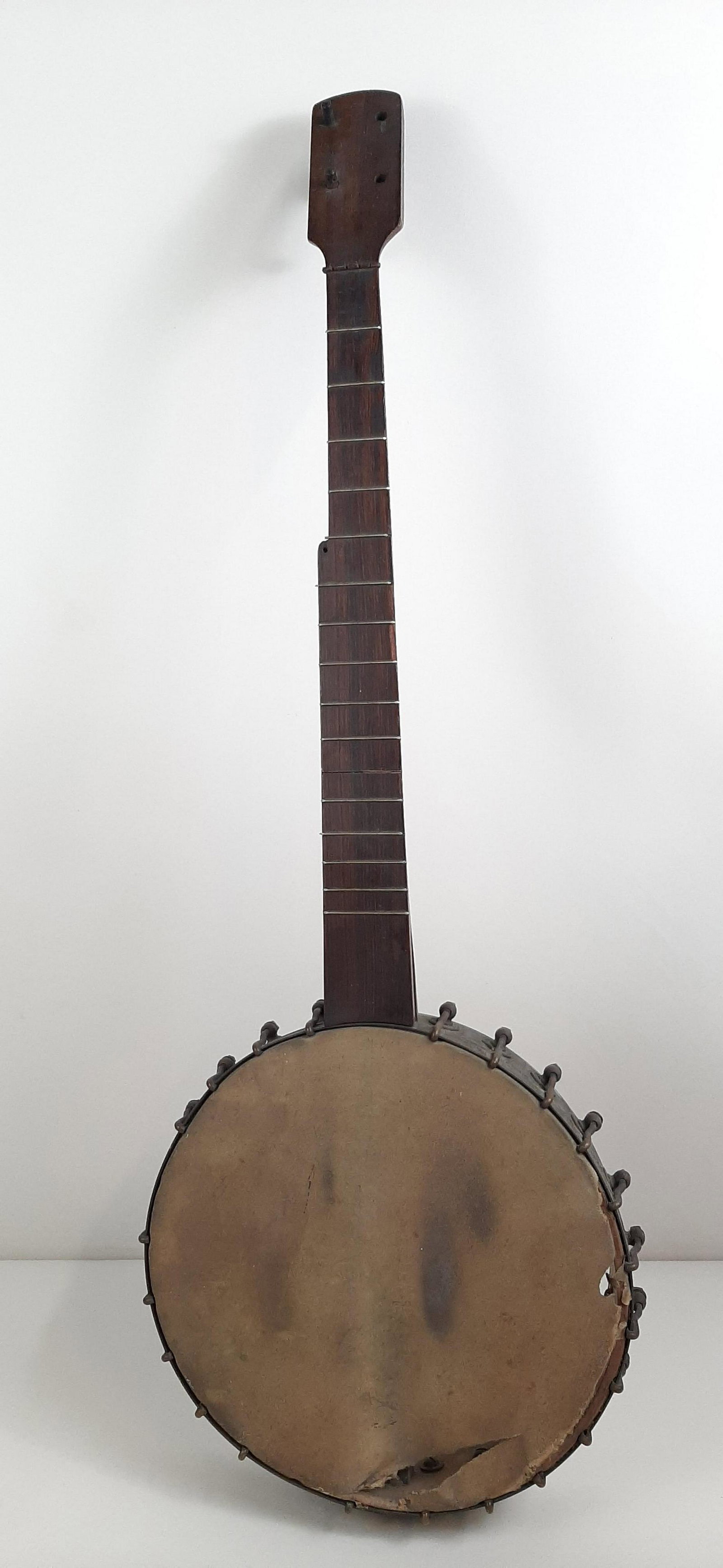 Antique Wood and Steel Banjo: Marked to inside "This banjo belongs to Revington Arthur, Oct. 23 1921." No string. Head ripped along rim. Missing 3 tuning pegs. IMPORTANT: Before bidding, please read the terms and conditions. When 