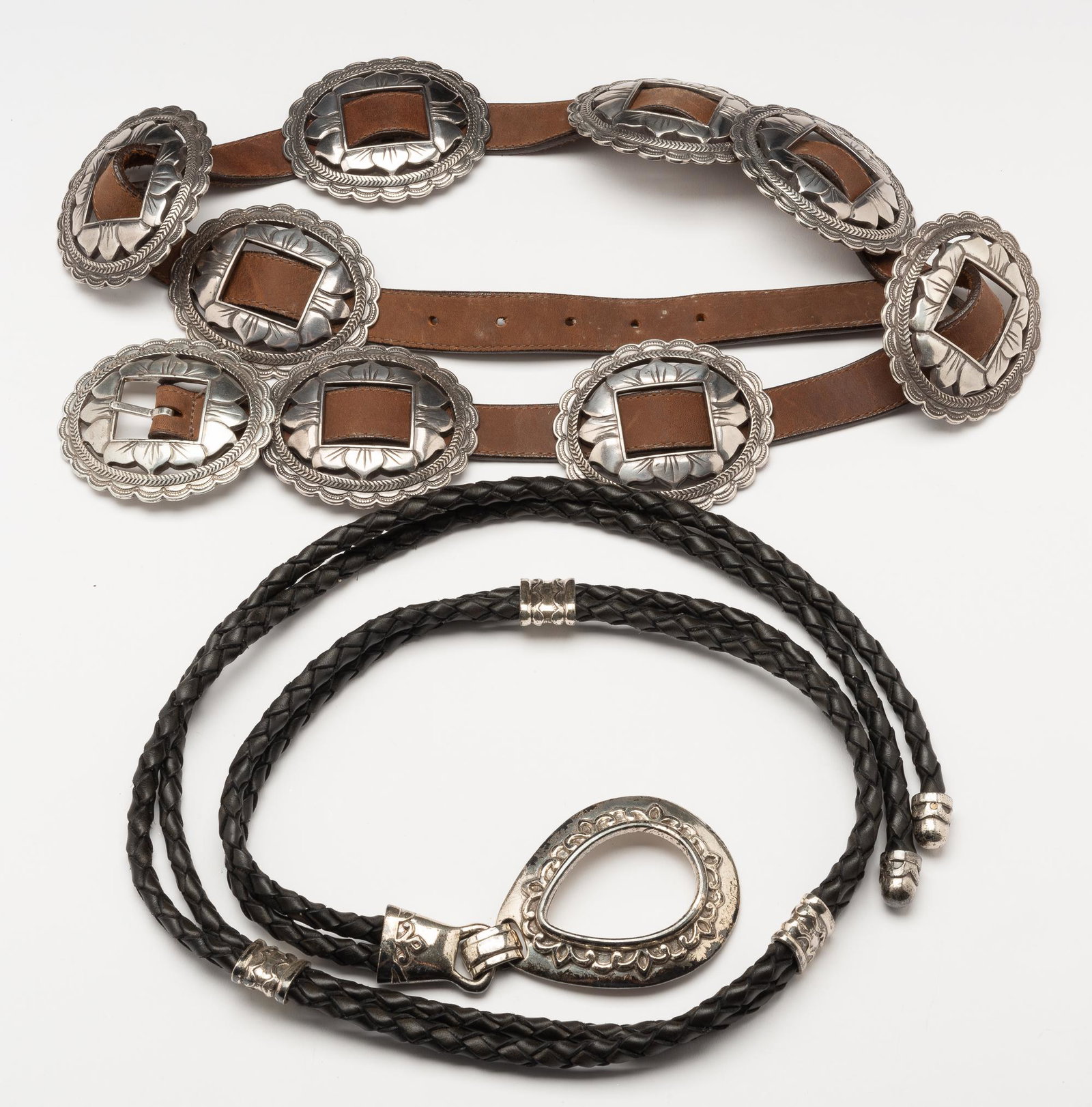 2 Ladies Belt Incl. Brighton: Black belt 49" long. Brighton belt 48" long, with 3-1/2" wide conchos.IMPORTANT: Before bidding, please read the terms and conditions. When you registered for the auction you agreed to these terms and