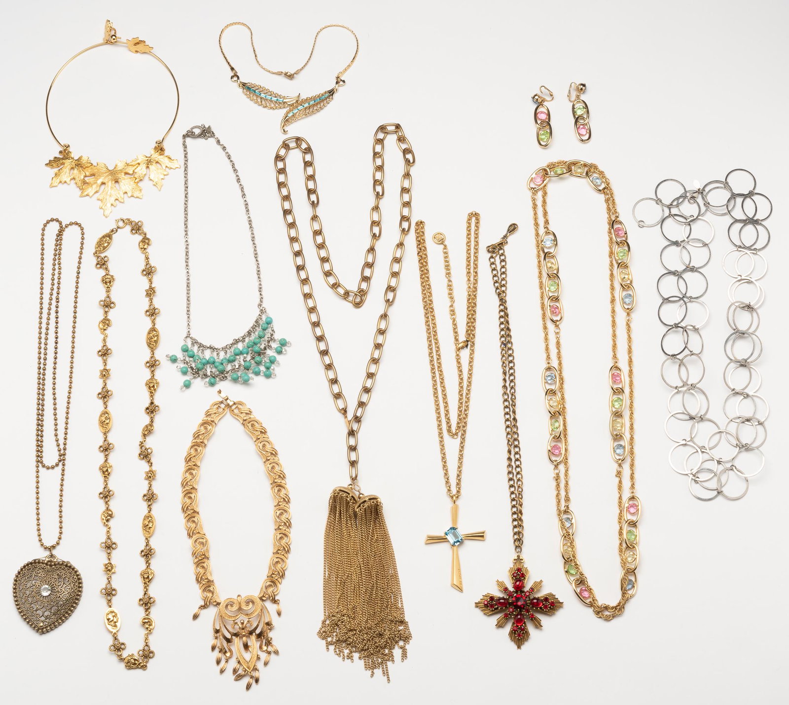 11 Pcs. Costume Necklaces: Necklace with cross 39" long. Necklace with tassels 38" long. Leaf necklace with blue stones 15" long. IMPORTANT: Before bidding, please read the terms and conditions. When you registered for the auct