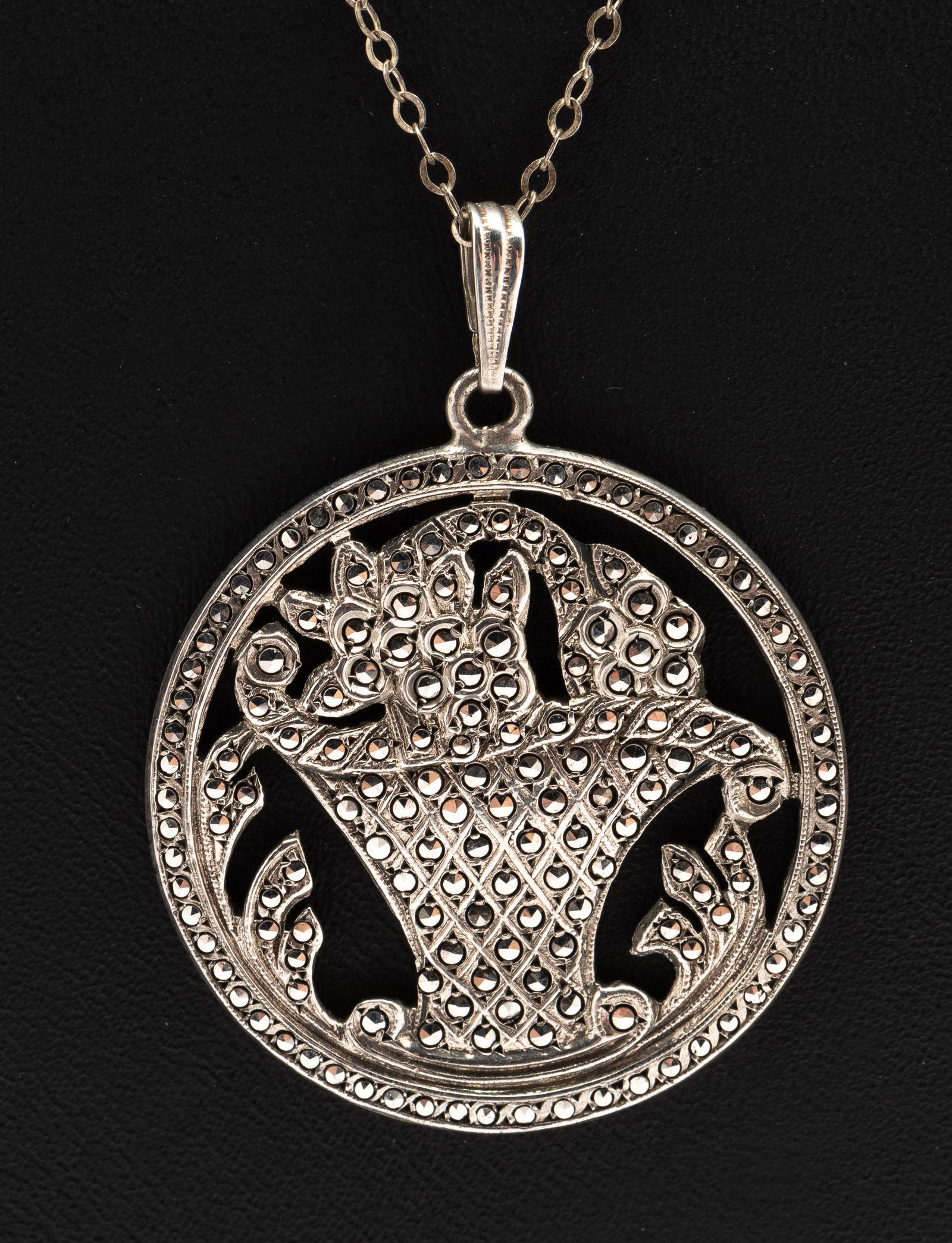 Antique Sterling and Marcasite Pendant: 1-1/4" diameter. Note 15" long chain is not sterling. IMPORTANT: Before bidding, please read the terms and conditions. When you registered for the auction you agreed to these terms and will be require