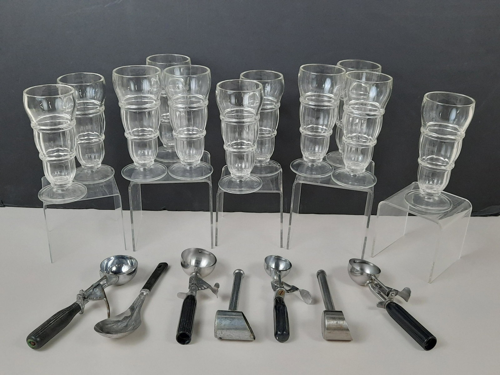 11 Ice Cream Soda Glasses & 7 Scoops: Glasses unmarked. Scoops from Hamilton Beach, Bi-cor, WM Son and unmarked. IMPORTANT: Before bidding, please read the terms and conditions. When you registered for the auction you agreed to these term
