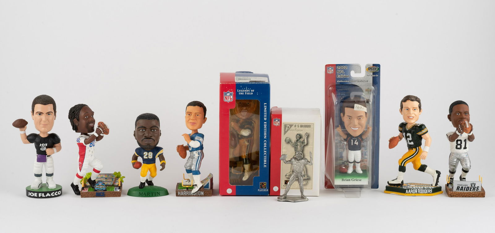 9 Football Figures & Bobbleheads: Includes McNabb pewter figurine, Joey Harrington, Tim Brown, Aaron Rodgers, Brett Favre, Brian Griese, Joe Flacco, Jerry Rice, and Curtis Martin. IMPORTANT: Before bidding, please read the terms and c