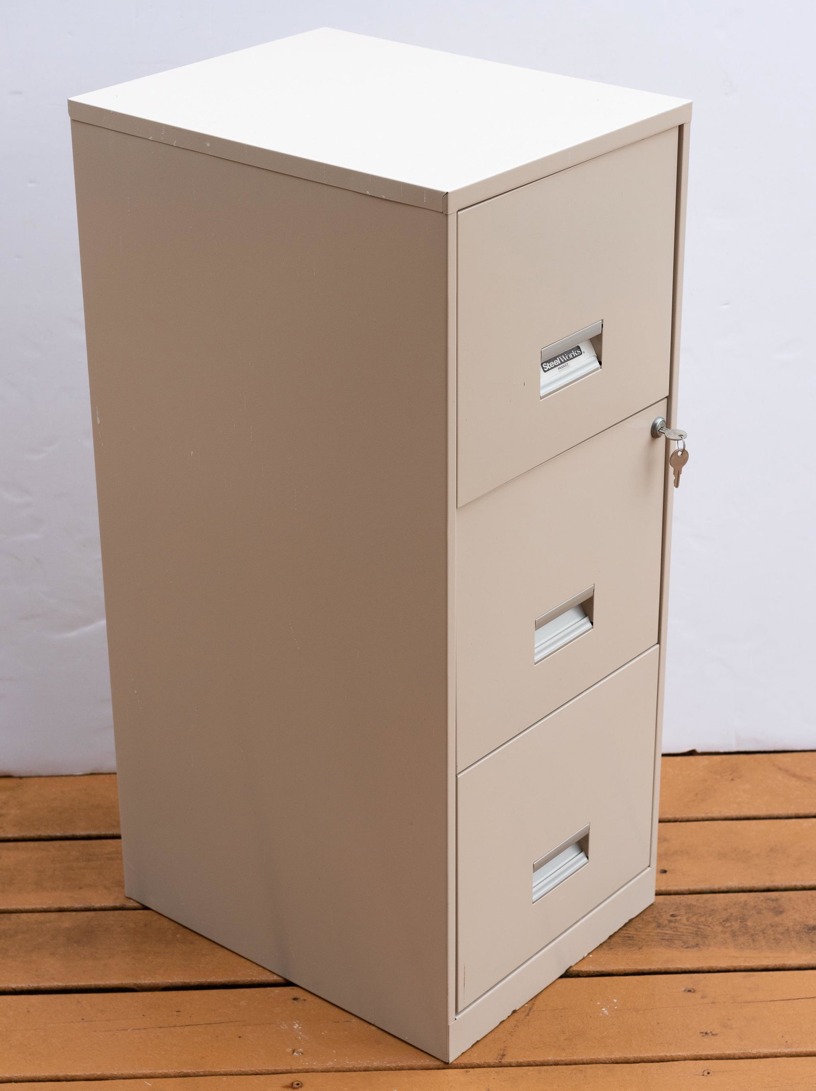 Steel Works 3 Drawer Filing Cabinet: With keys. 14-1/4" wide x 18" deep x 35-1/2" high. IMPORTANT: Before bidding, please read the terms and conditions. When you registered for the auction you agreed to these terms and will be required t