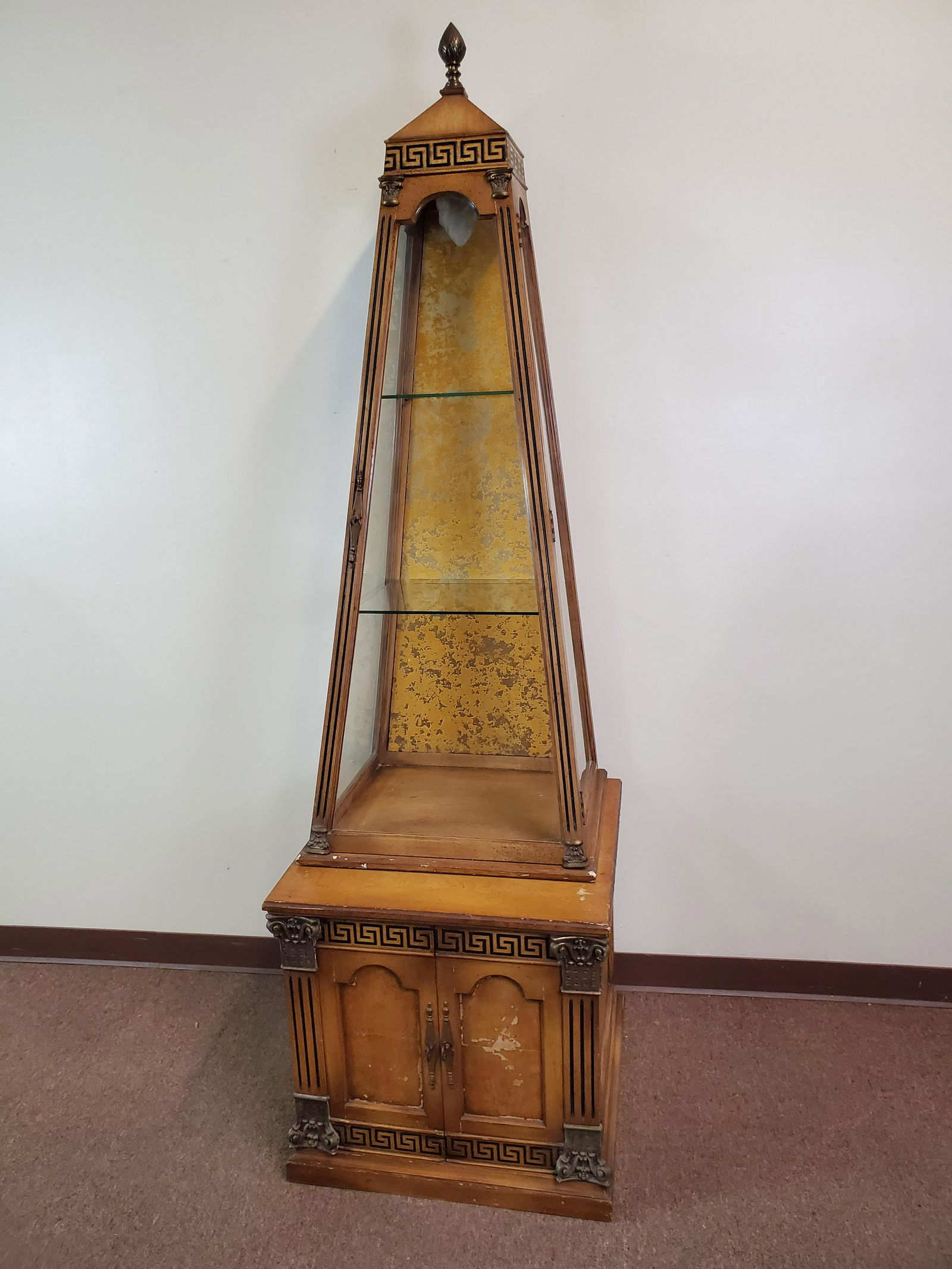Obelisk Lighted Curio Cabinet: 24" wide X 23 1/2" deep X 83" high. Working. Has chips and finish loss.