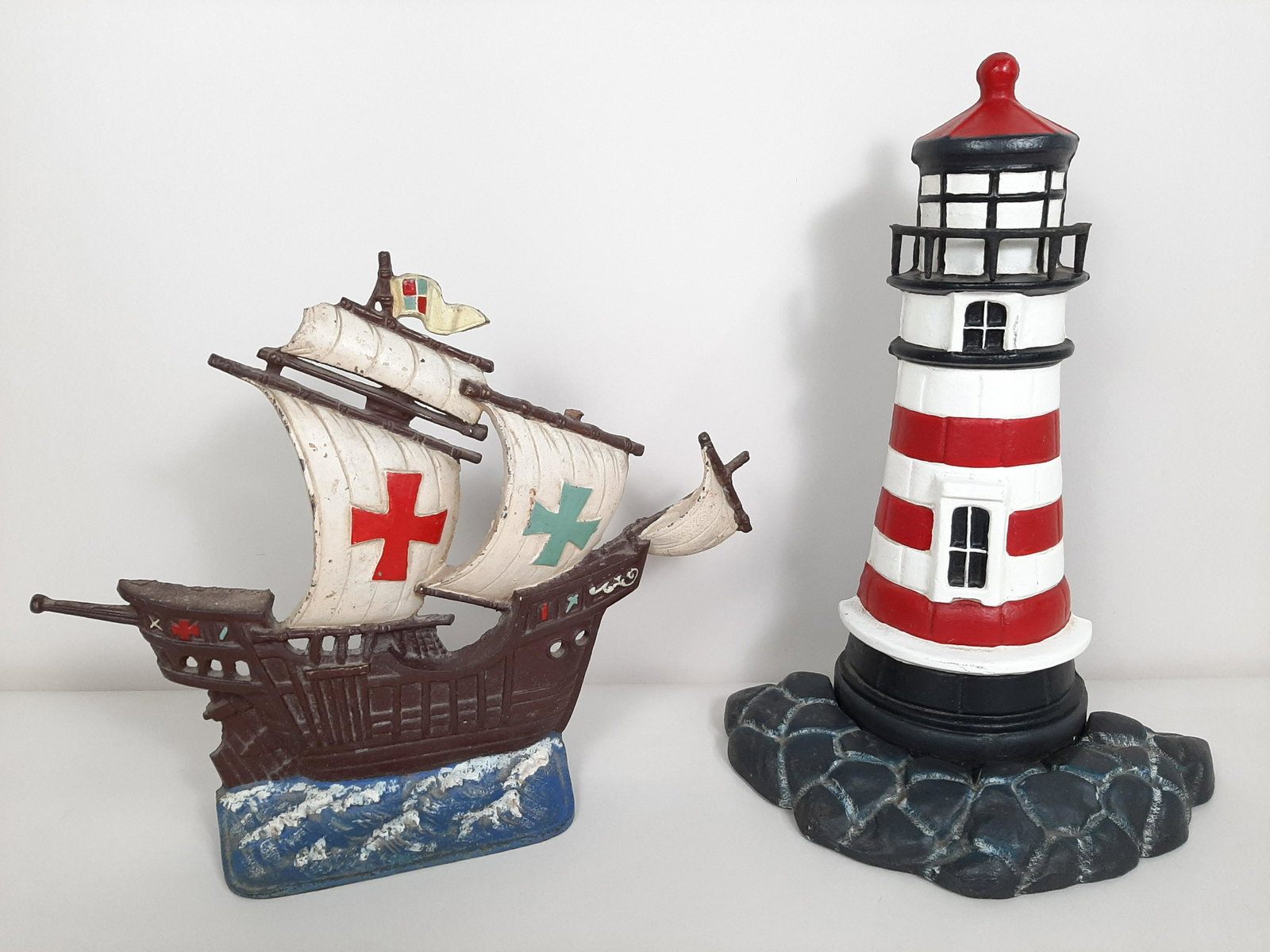 2 Cast Iron Nautical Door Stops: Includes ship and lighthouse. 10¼" to 13¾" wide X 11" to 14¼" high.