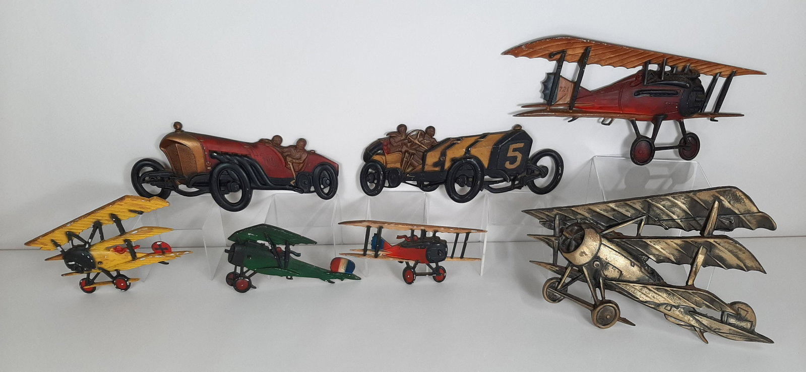 7 Cast Metal Plane and Auto Wall Plaques: Includes Sexton and Homco. 10½" to 20¼" wide X 5¾" to 12½" high.