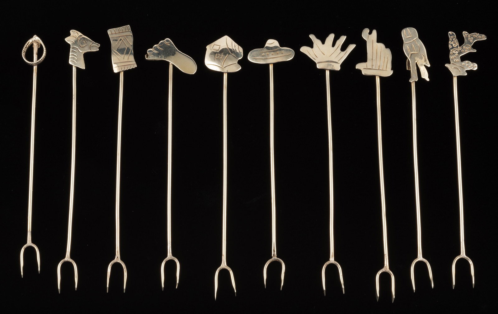 10 Sterling Olive Picks: No maker's mark. Each with different Southwestern theme heads, including sombrero, donkey, cactus, etc. 0.8 ozt. total. Each 4 1/2" long. IMPORTANT: Before bidding, please read the terms and condition