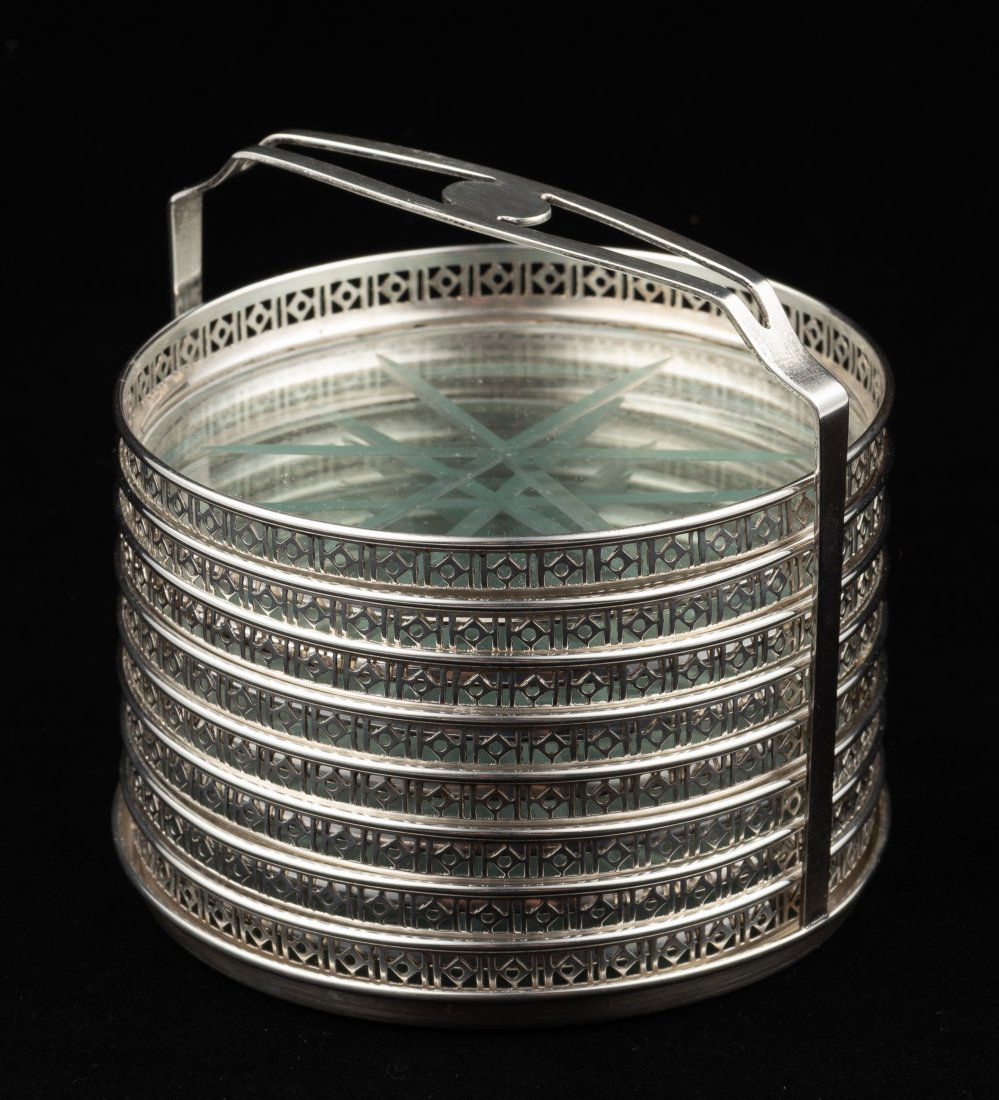 8 Webster Sterling Coasters w/ Glass Bottoms: In holder. Each 3" diameter. Crack to one of the coaster glass bottoms. IMPORTANT: Before bidding, please read the terms and conditions. When you registered for the auction you agreed to these terms a