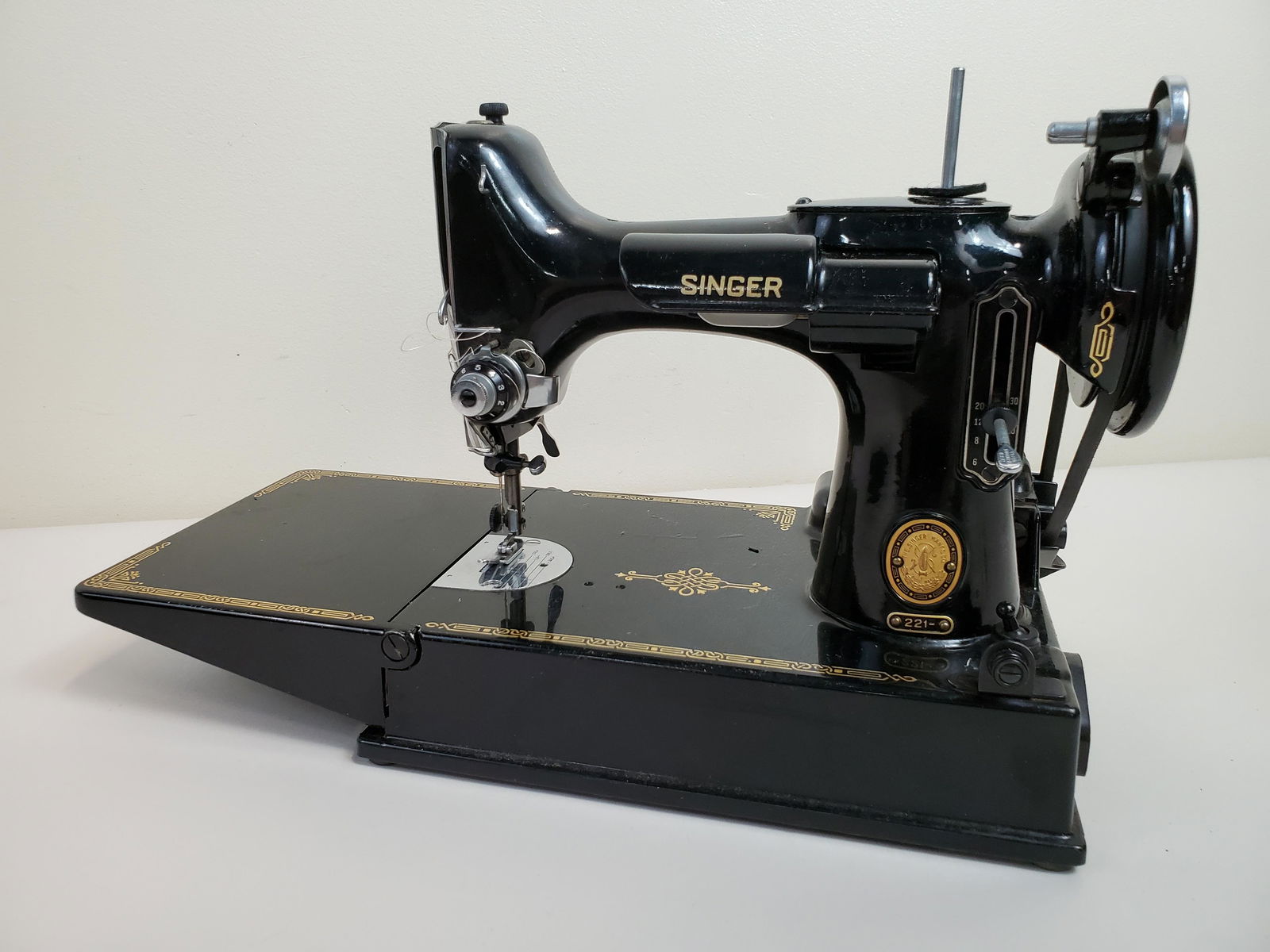 Singer Featherweight Sewing Machine: Working. Cord dry rot. Bobbin unmarked. 15" wide X 7" deep X 9 1/2" high. IMPORTANT: Before bidding, please read the terms and conditions. When you registered for the auction you agreed to these terms