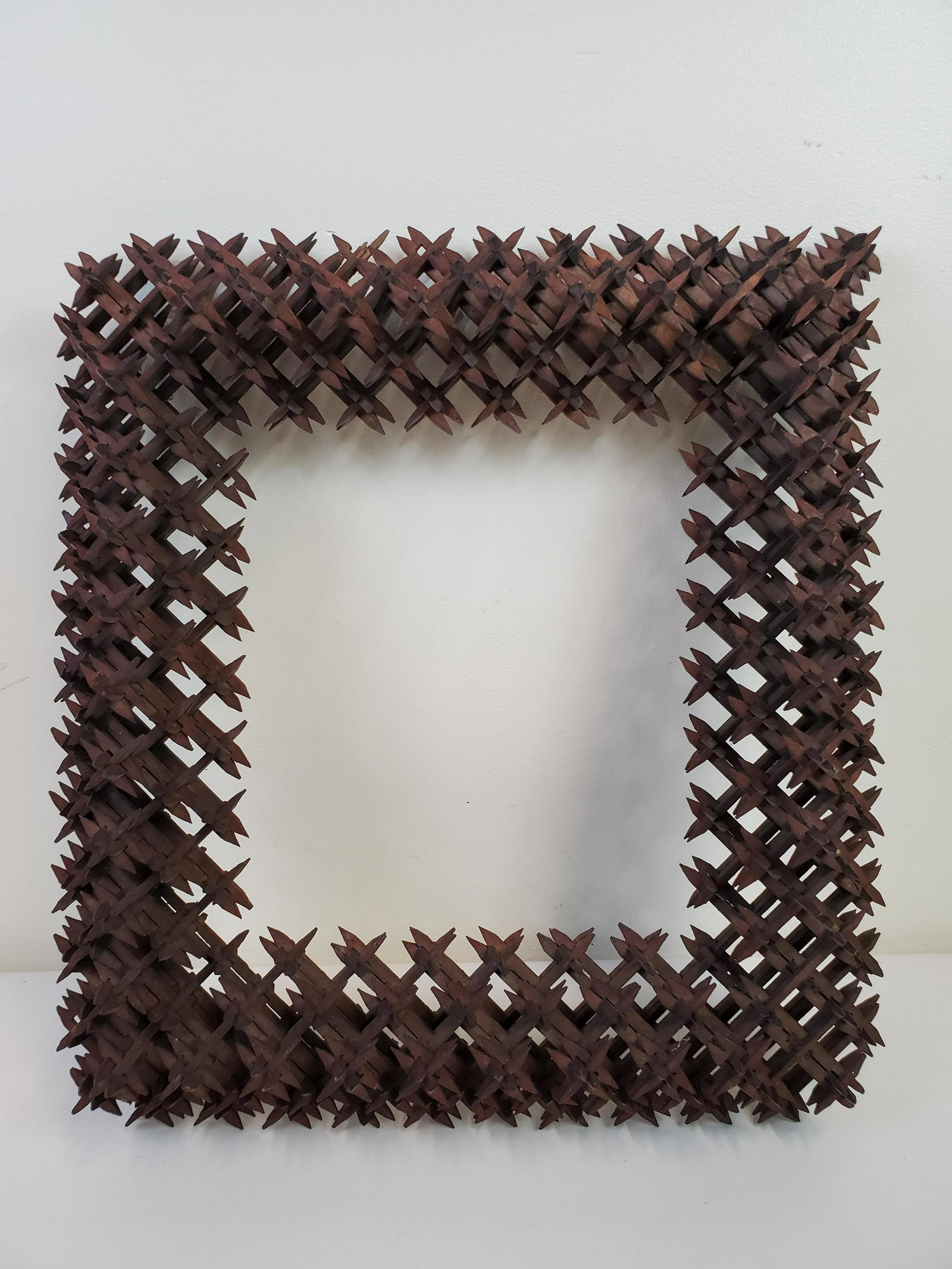 Tramp Art Frame: 17" wide X 19" high. Has some losses. IMPORTANT: Before bidding, please read the terms and conditions. When you registered for the auction you agreed to these terms and will be required to comply with