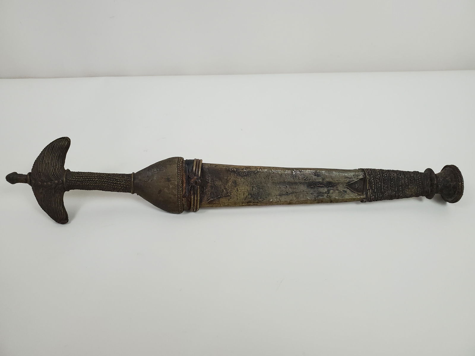 Brass Knife With Sheath: With intricate applied decoration. Acquired in Nigeria 1967-1968. 3 1/2" wide X overall with sheath 18 1/4" long. Blade lengh 5 1/4" long. IMPORTANT: Before bidding, please read the terms and conditio