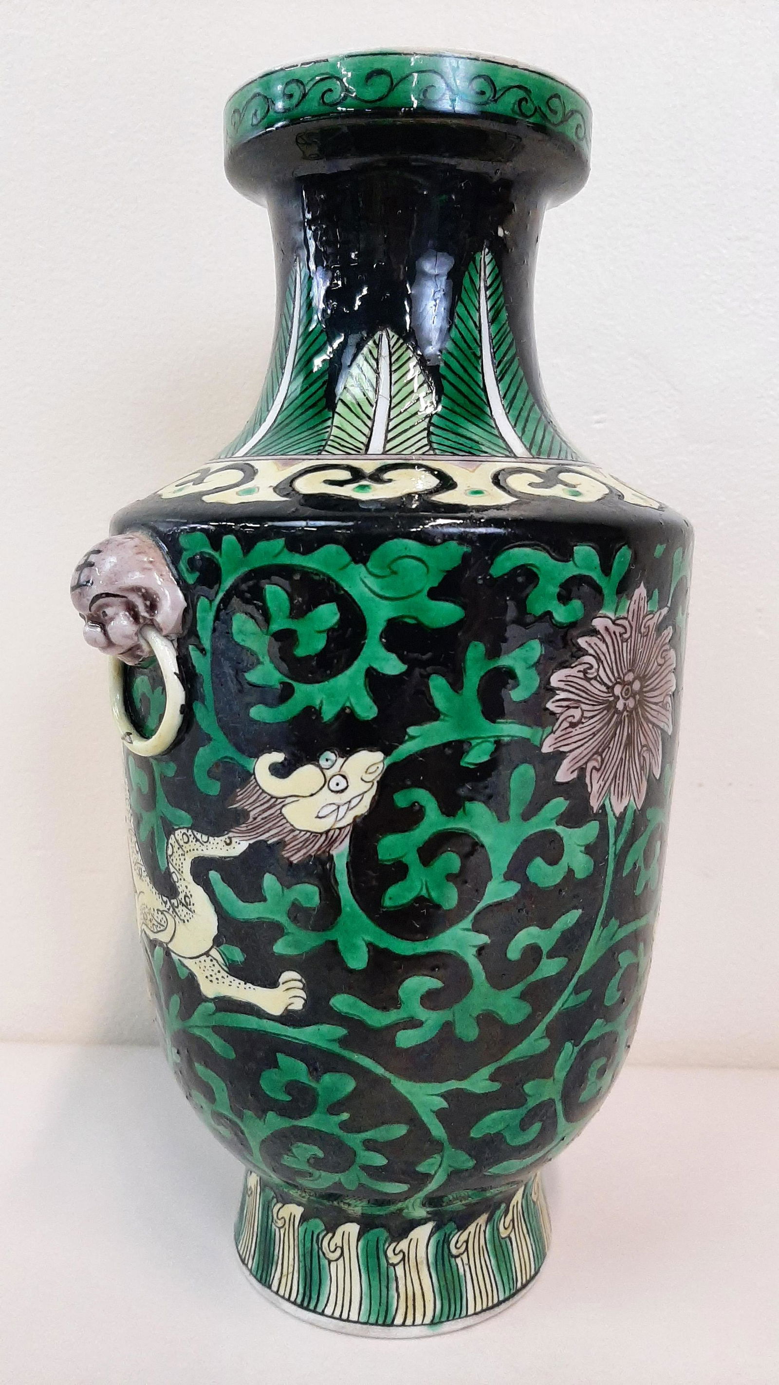 Chinese Famille Verte Vase: Black background with lion face handles on Rouleau form. 20th C. 4½" diameter X 8¾" high. Chip to inner rim. IMPORTANT: Before bidding, please read the terms and conditions. When you registered for