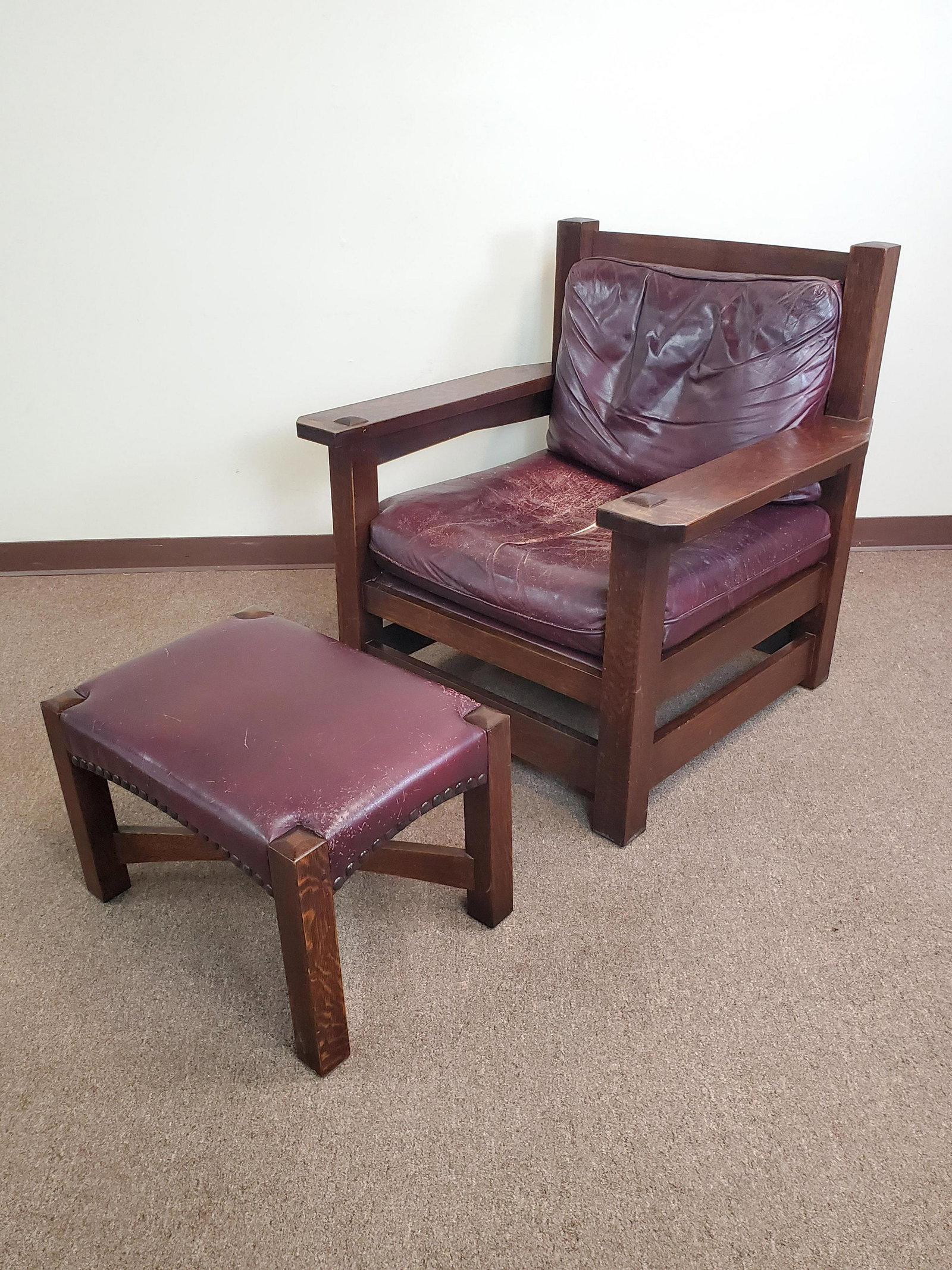 Stickley Arm Chair & Ottoman: Chair 36" wide X 32 1/2" deep X 36 1/2" high. Ottoman 24" wide X 17" deep X 16 1/2" high. Leather on chair and ottoman has heavy wear. Seat on chair has tear down middle. Some discoloring on ends of a