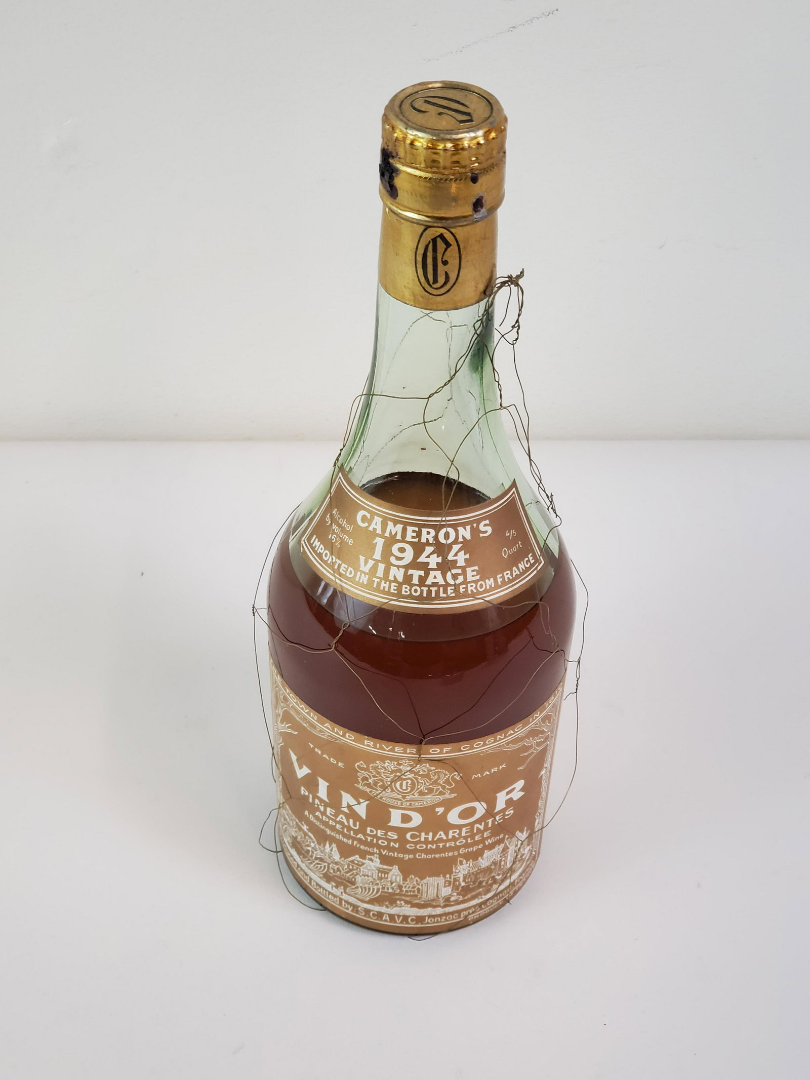 Vin D'or Estate Wine: Cameron's 1944 vintage bottle imported from France. 4/5 quart. This bottle is sealed / unopened. This lot is available for pick up only. IMPORTANT: Before bidding, please read the terms and conditions