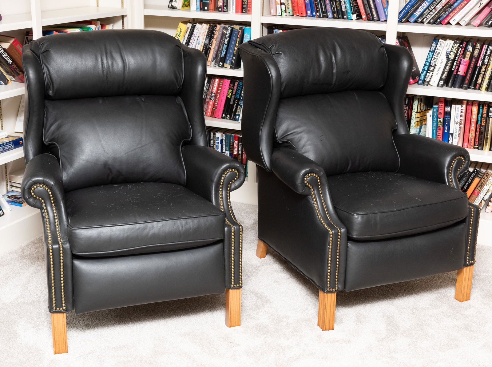 Pair of Alexander Taylor Leather Recliners: Black leather with nail head trim. 32" wide x 33" deep x 42" high. 61" deep when extended. Wear to seat cushions. IMPORTANT: Before bidding, please read the terms and conditions. When you registered f