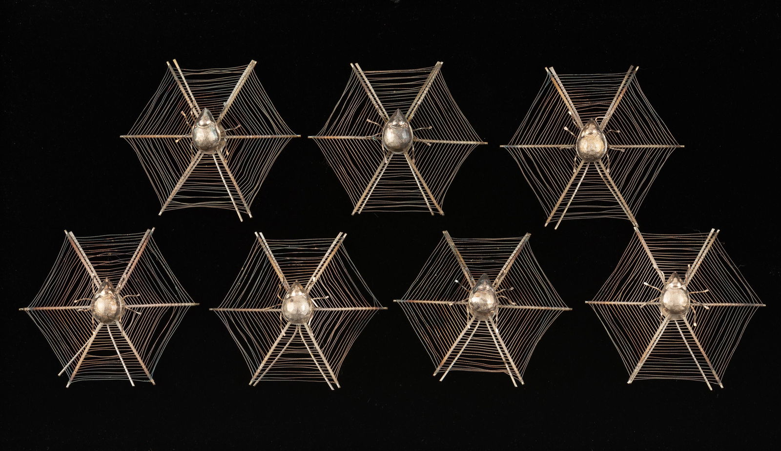 7 Chinese White Metal Spider Place Card Holders: 7 Chinese export white metal place card holders in a web shape, each with a spider in the center of web. MEASUREMENTS: 2-1/2 " high. CONDITION: No defects noted. IMPORTANT: Before bidding, please read