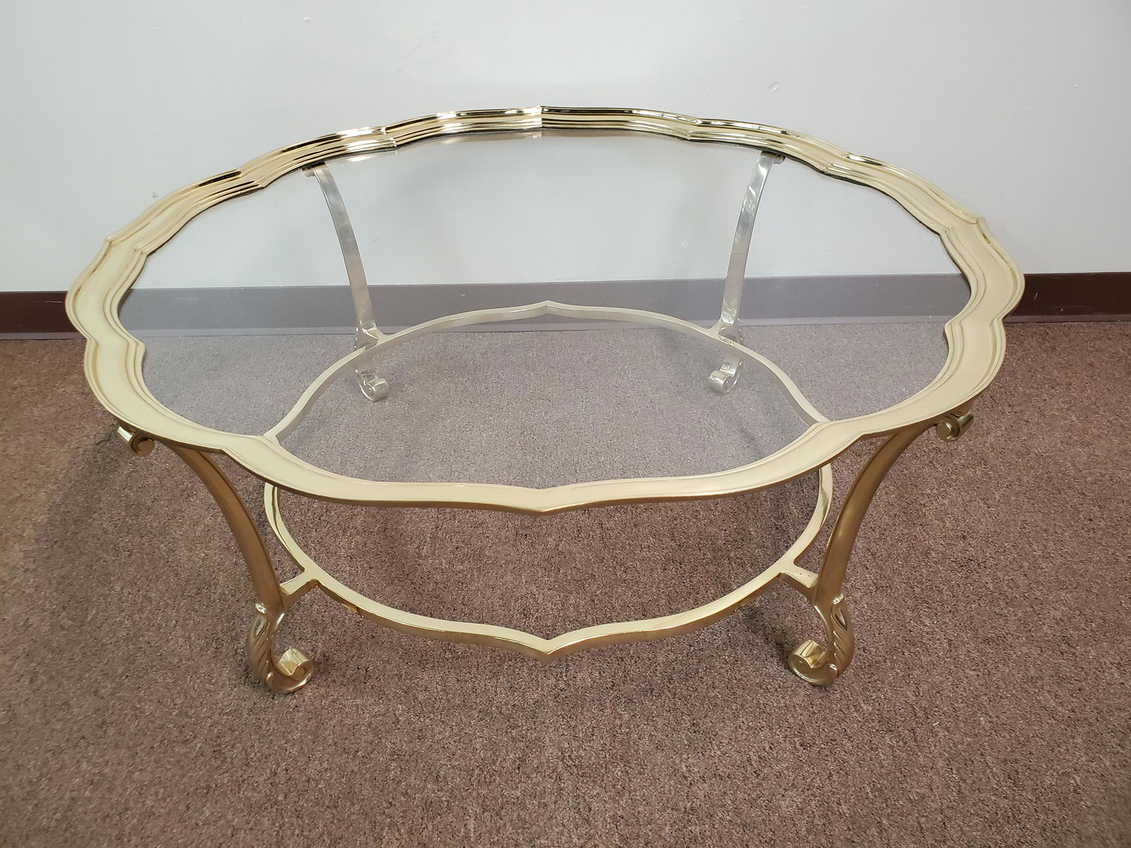 Glass Top Brass Coffee Table: 41 1/2" diameter X 17" high. IMPORTANT: Before bidding, please read the terms and conditions. When you registered for the auction you agreed to these terms and will be required to comply with them.
