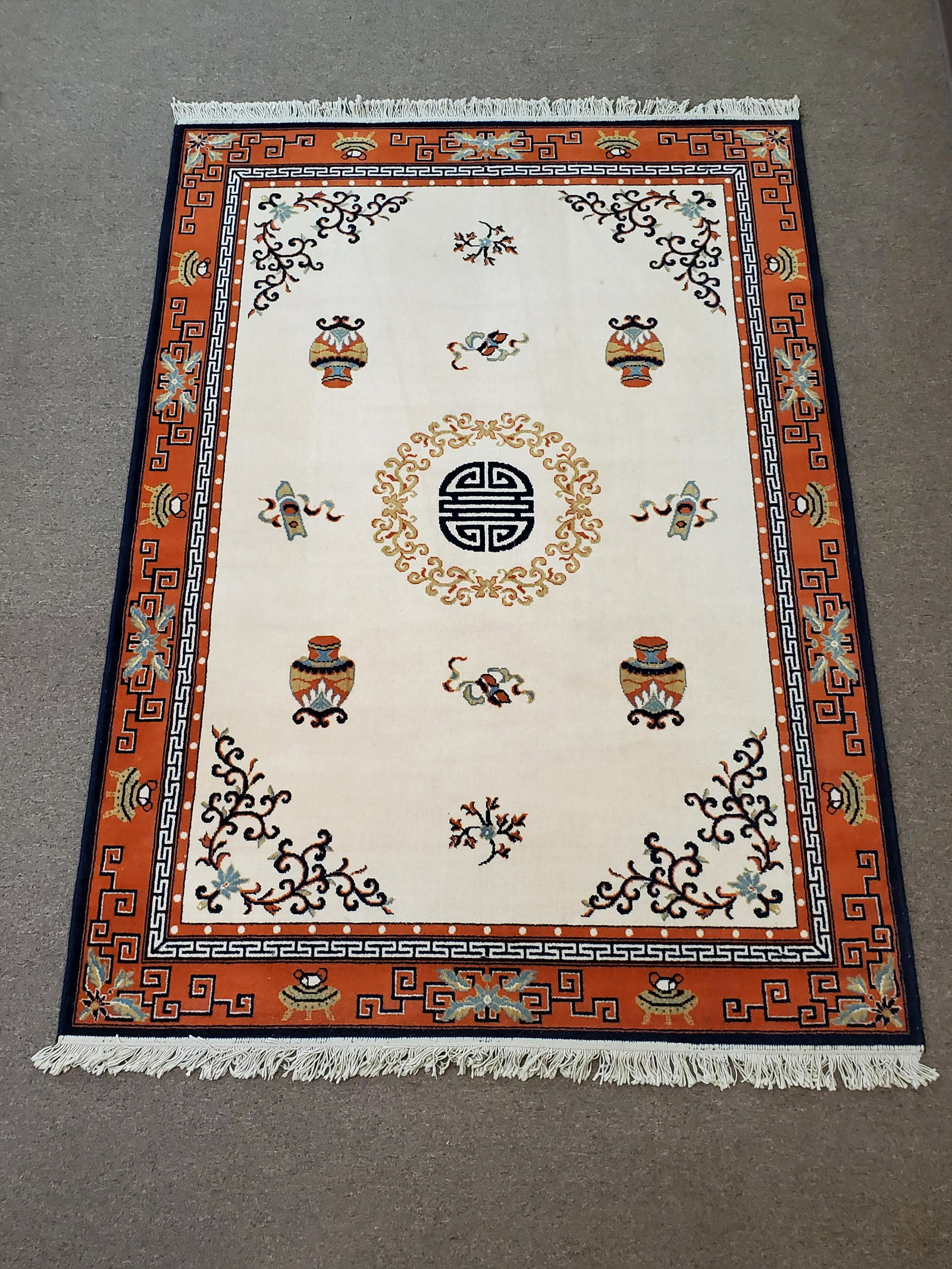 Almatex Spanish Wool Area Rug: Wool. Red and navy blue on ivory ground. 67" wide X 93" long. Has some discoloration. IMPORTANT: Before bidding, please read the terms and conditions. When you registered for the auction you agreed to