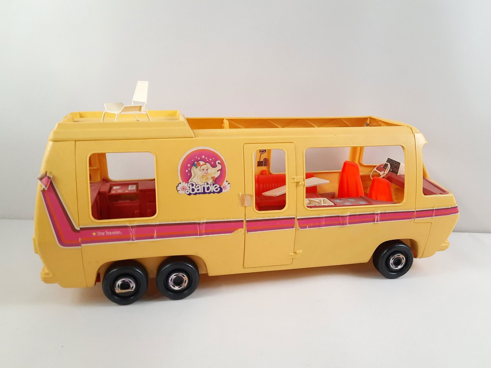 Barbie Star Traveler Van: 36" long x 14-1/2" high. Some sticker peeling and losses. Some furniture bent. IMPORTANT: Before bidding, please read the terms and conditions. When you registered for the auction you agreed to these