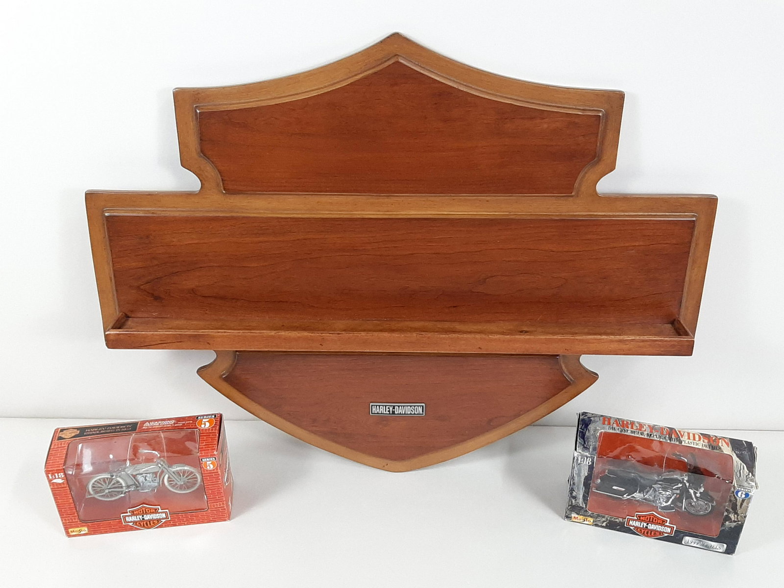 Harley-Davidson Display and 2 Die Casts: Maisto Die Cast Motorcycles; both 1:18 scale. Display: 26" wide X 20" high. IMPORTANT: Before bidding, please read the terms and conditions. When you registered for the auction you agreed to these ter