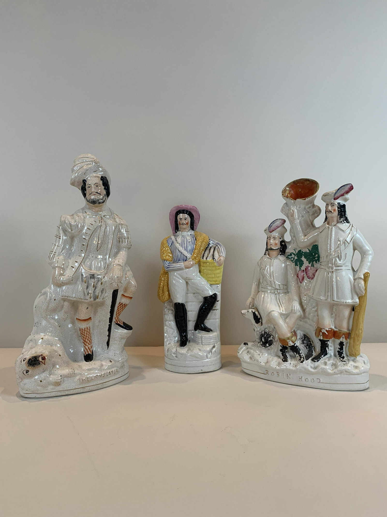 3 Staffordshire Figures: The Lion Slayer, 17" high, heavy crazing. Robin Hood, 15" high, moderate crazing. Unmarked, 13-1/4" high, light crazing and cracks. IMPORTANT: Before bidding, please read the terms and conditions. Whe